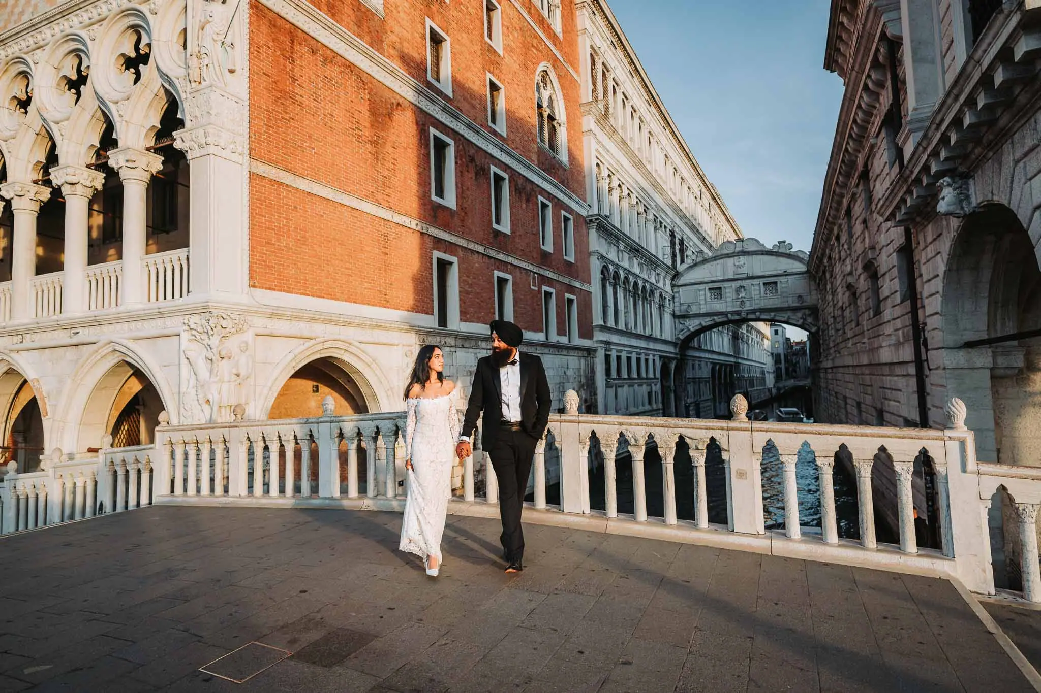Romantic couple walking in Venice, Italy at sunset, capturing wedding and engagement moments.