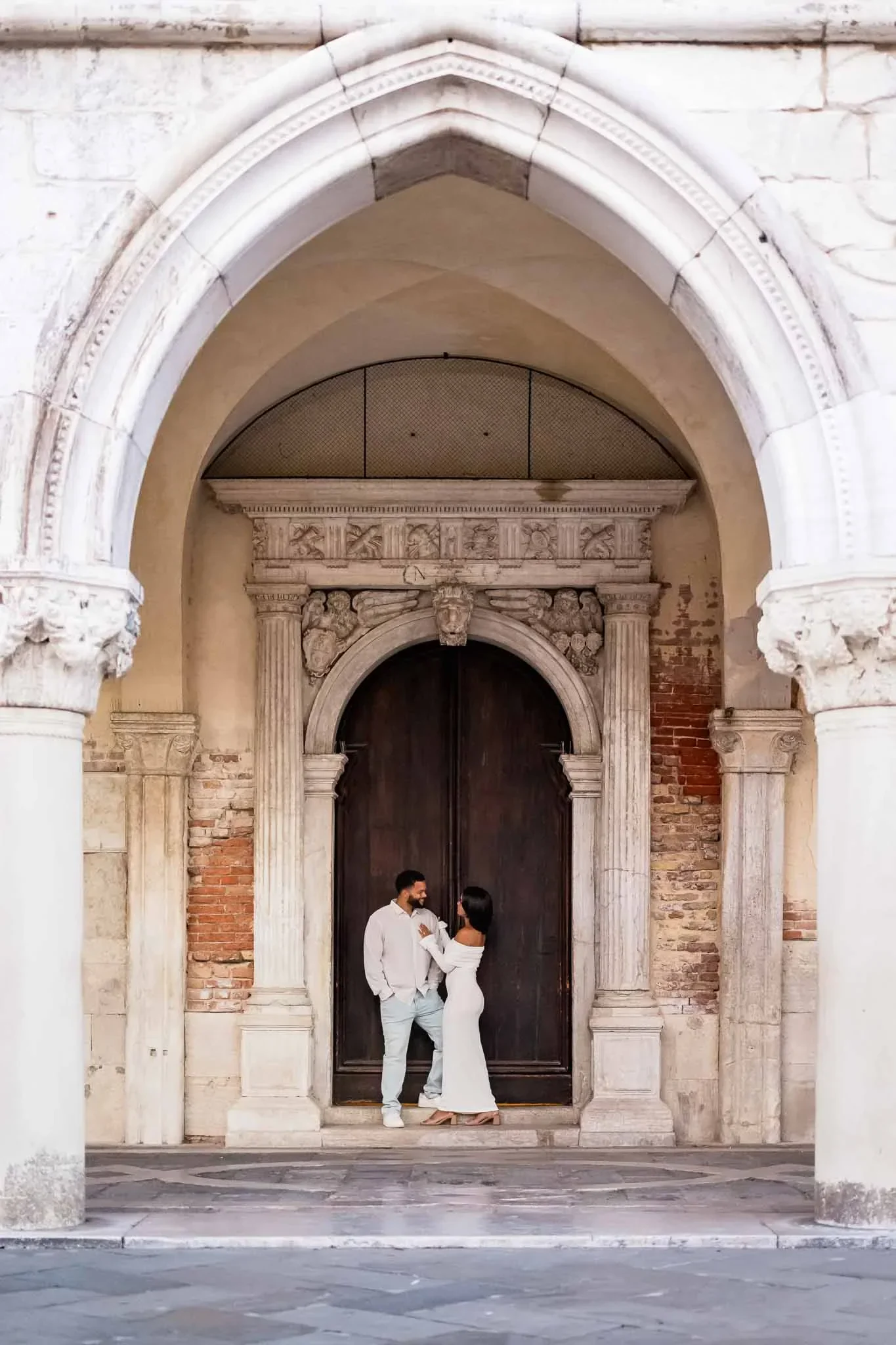 Couple under a beautiful archway.