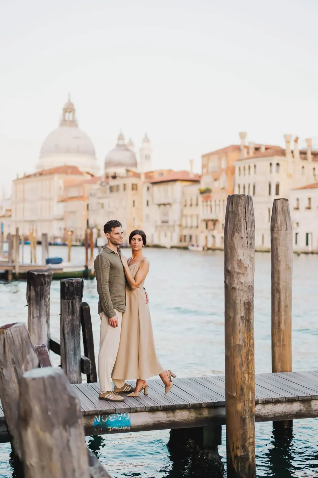 Couple embracing by the waterfront.