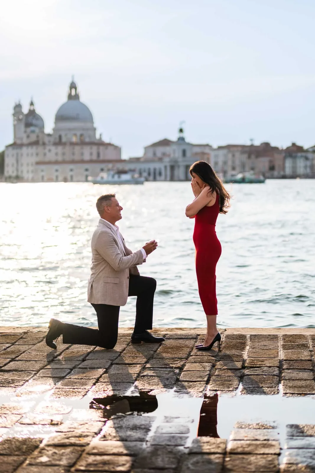 1. Romantic proposal in Venice by the water with a classic cityscape backdrop.