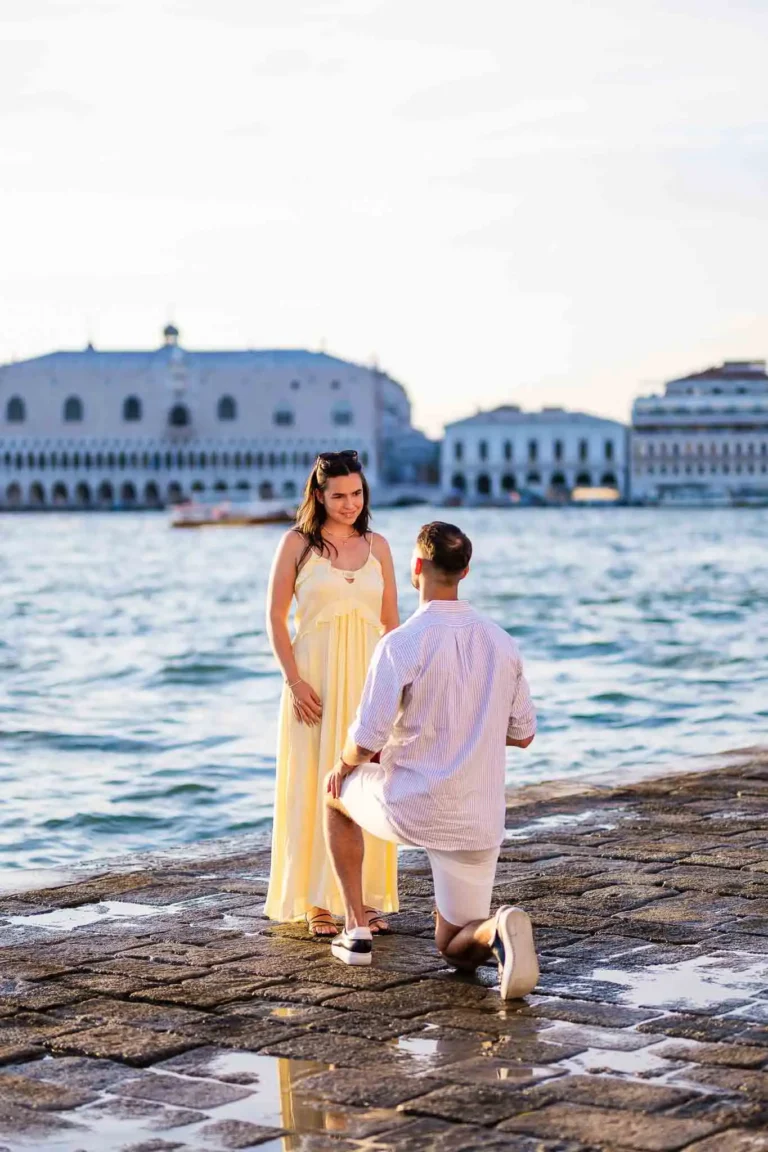 Elegant woman in yellow dress proposing on Venice waterfront during sunset.