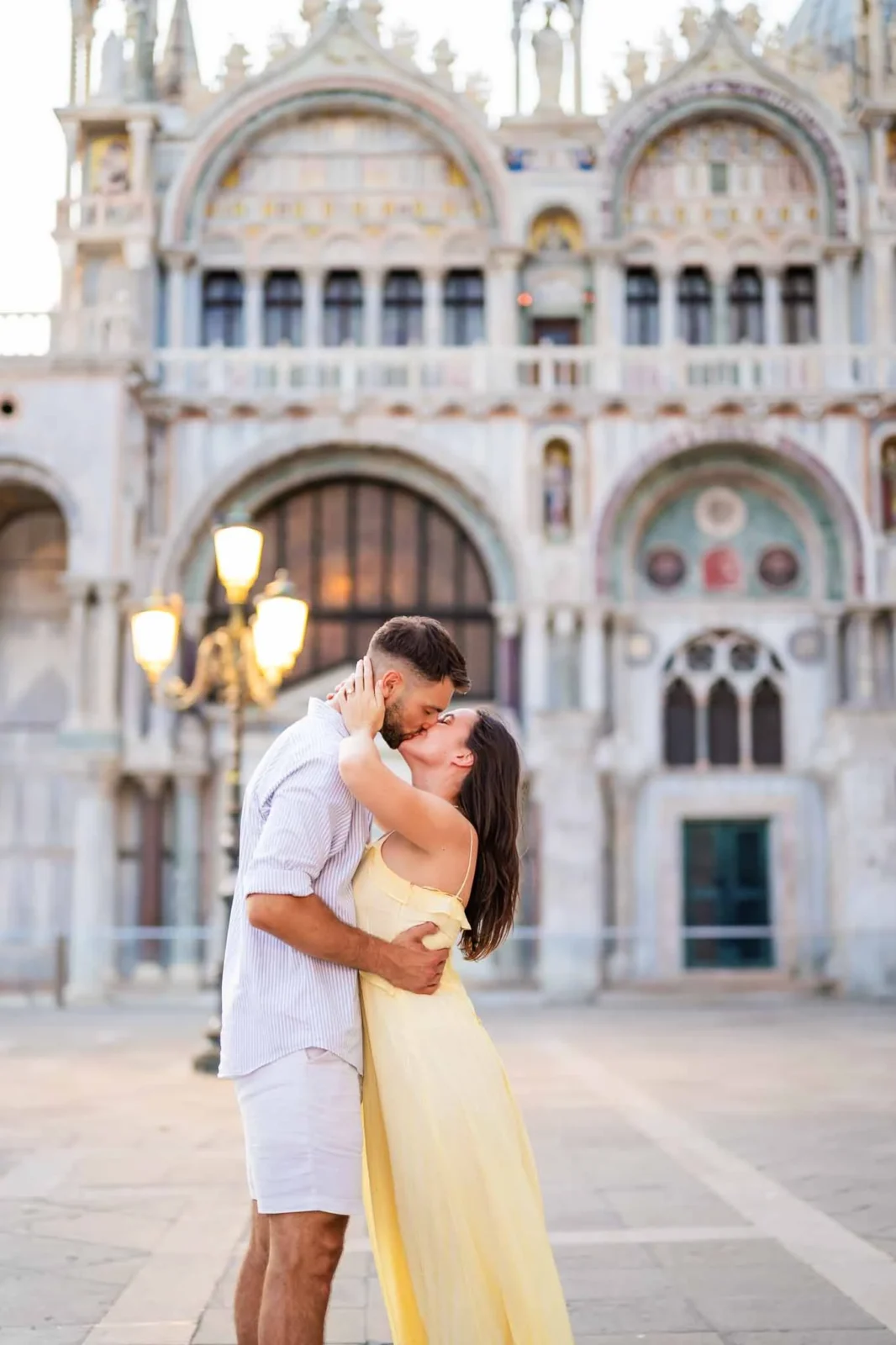 1. Romantic couple kissing in front of Venice historic architecture, proposal photography.