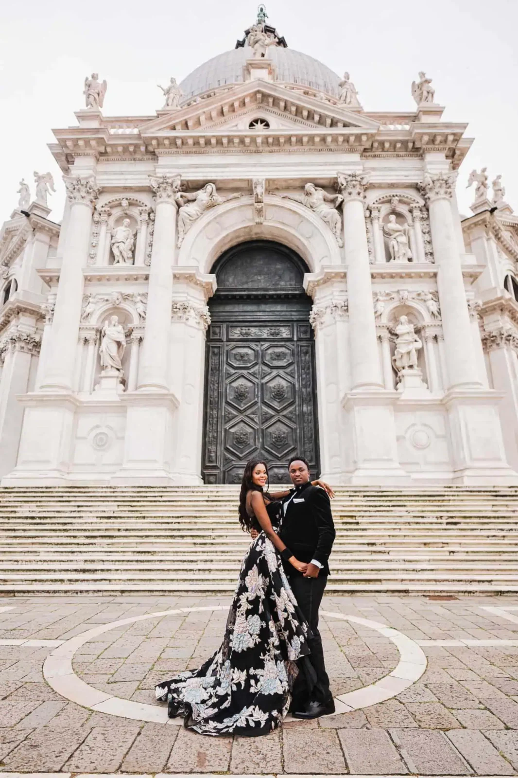 Elegant couple in wedding attire at Venice's church, capturing romantic engagement moments.