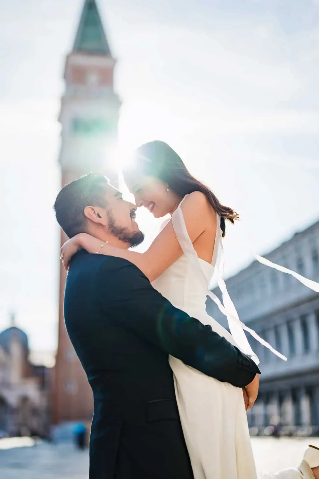 1. Romantic couple in Venice with St. Mark's bell tower in the background, capturing love and engagement.
