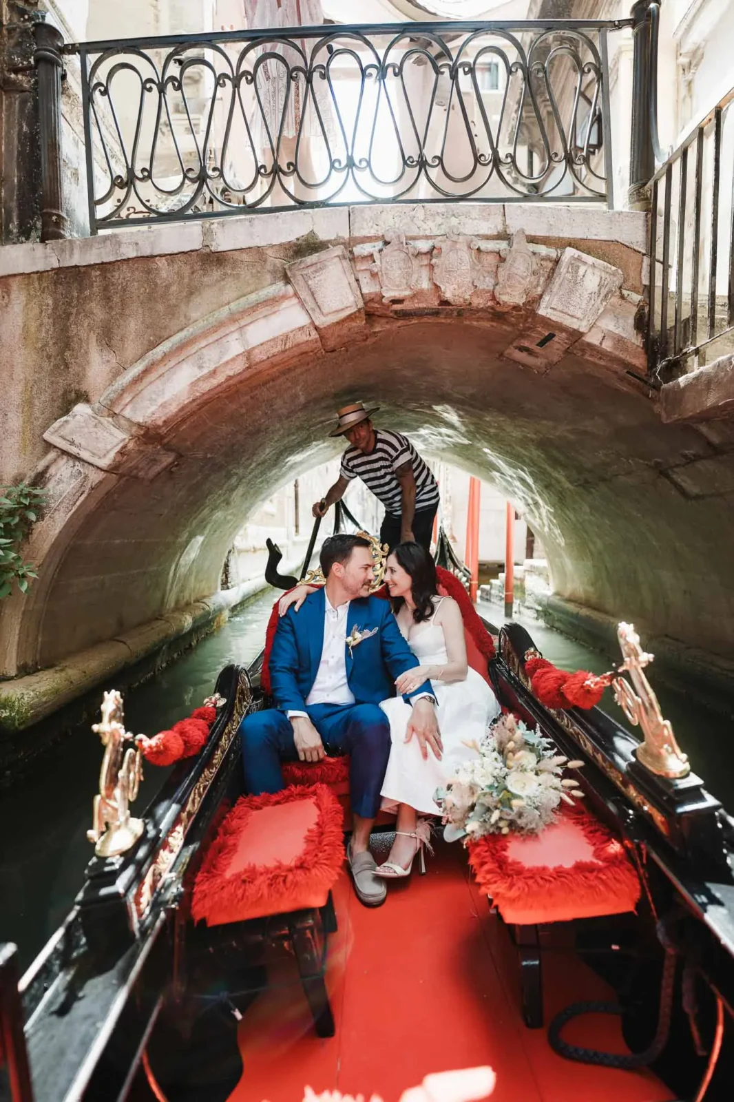 Romantic wedding couple in gondola under Venice bridge, Italian wedding photography, love story in Venice.