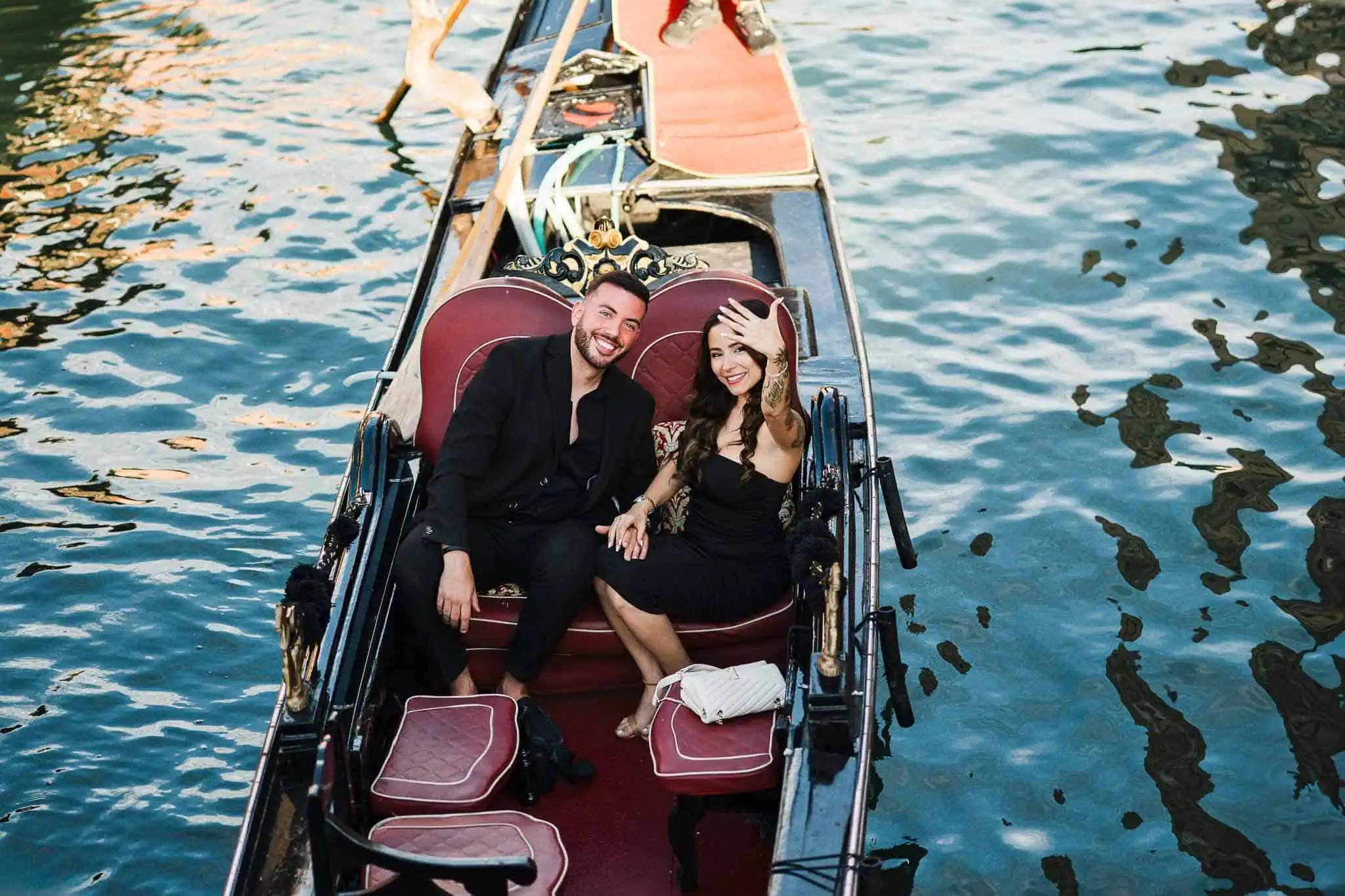 Romantic Venice gondola ride with couple, wedding or engagement photoshoot, picturesque canal scene, Venice, Italy.