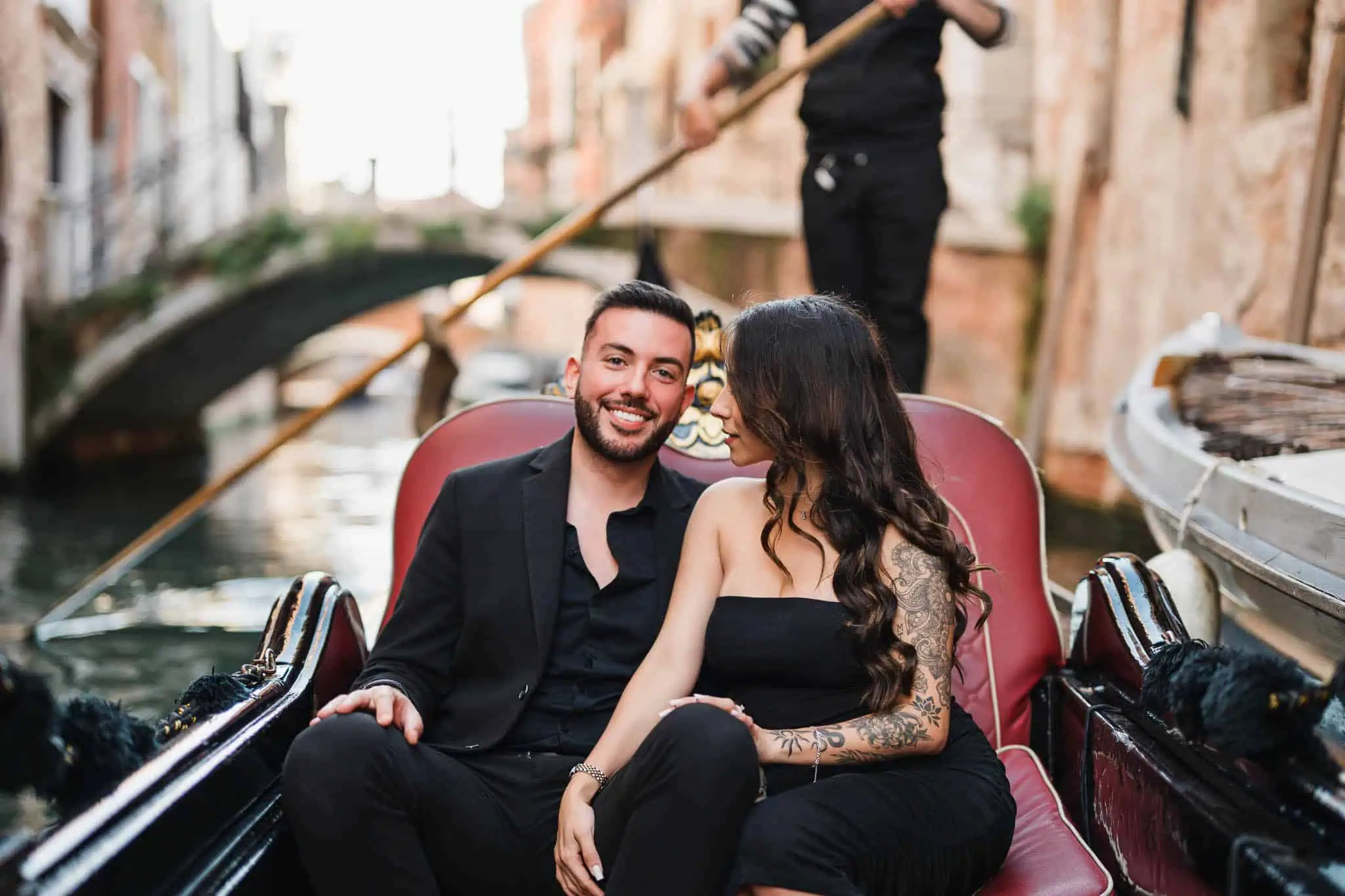 Romantic Venice gondola proposal with couple enjoying a scenic canal ride.