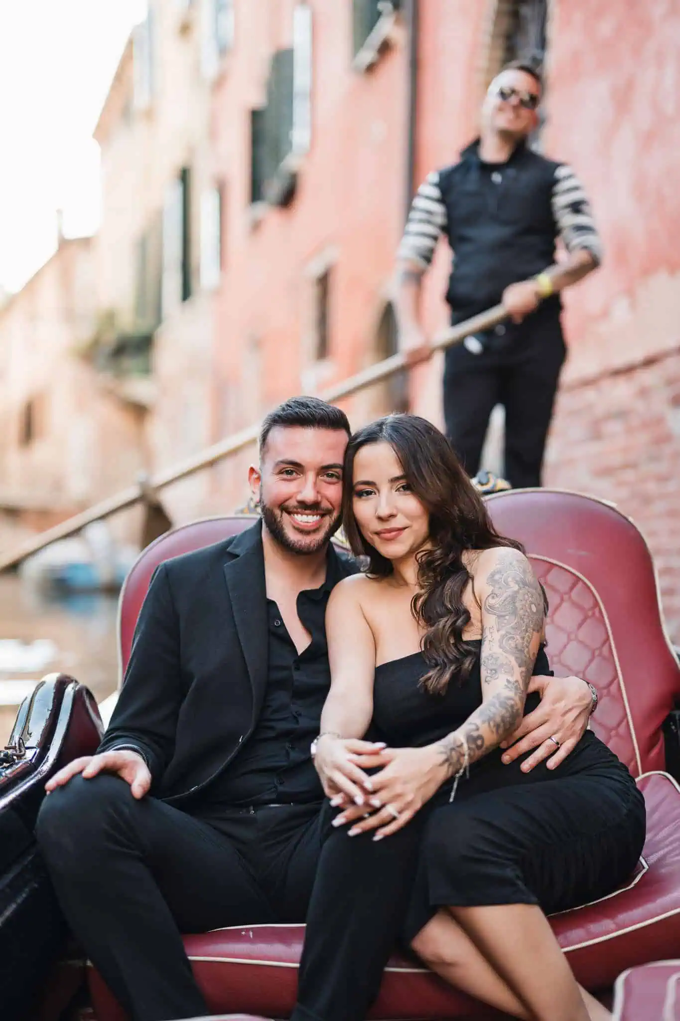 Elegant couple in a gondola enjoying Venice’s romantic atmosphere, captured by a Venice wedding & engagement photographer.