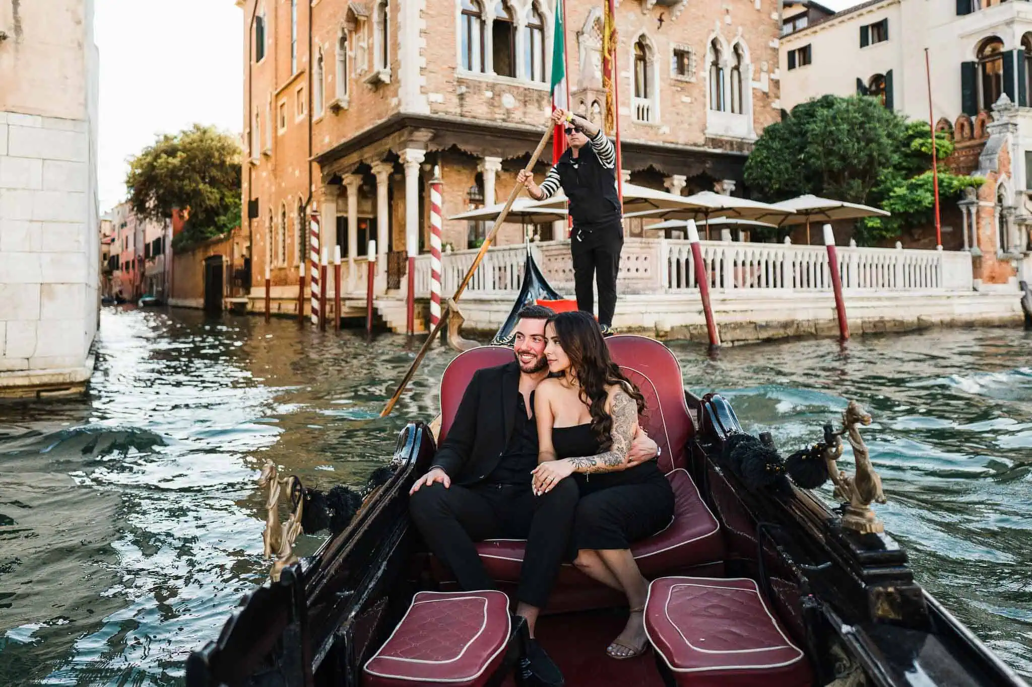 Romantic Venice gondola with couple, wedding proposal, and gondolier in historic Venice, Italy.