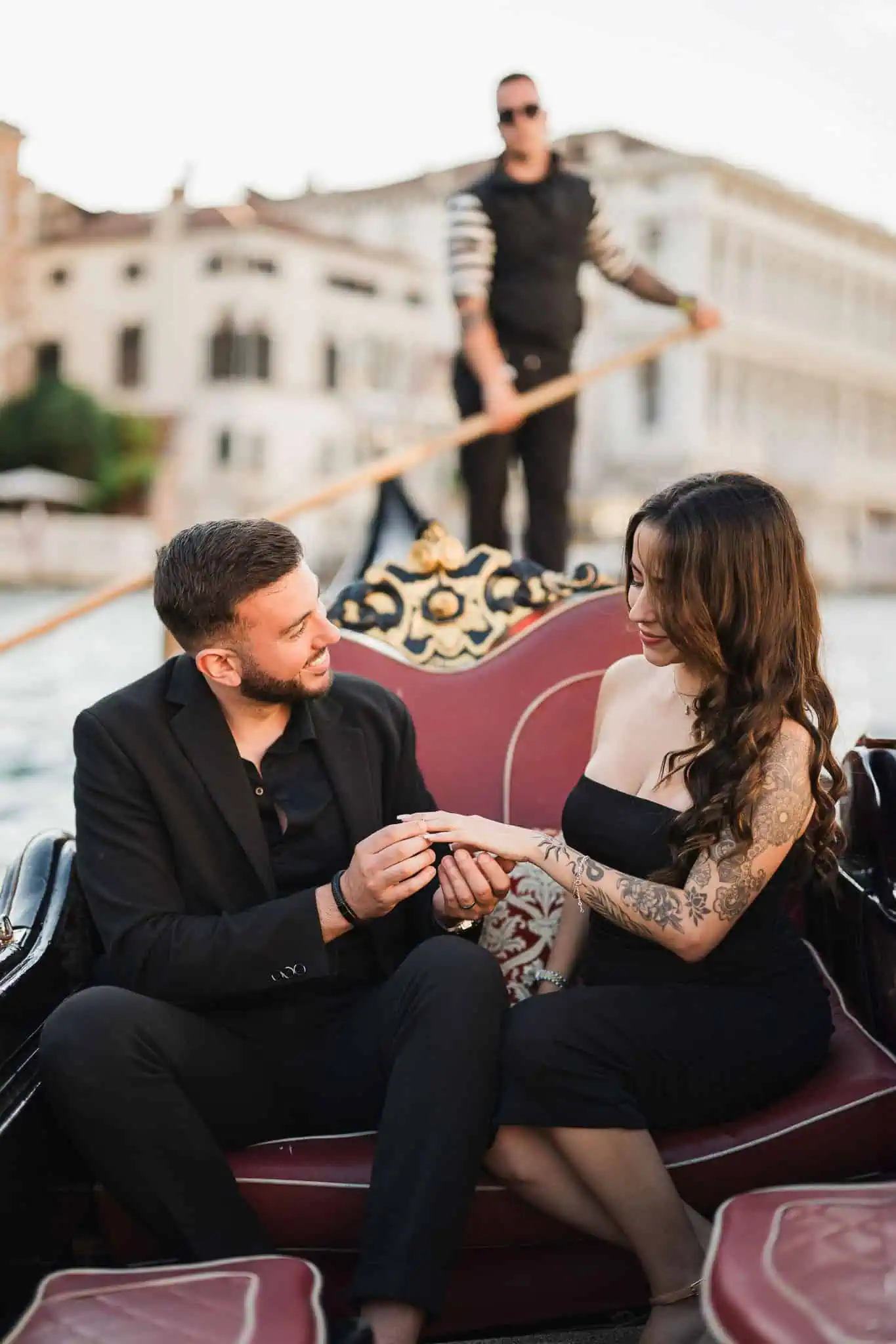 Romantic couple during a gondola proposal in Venice, captured by a professional wedding and engagement photographer.
