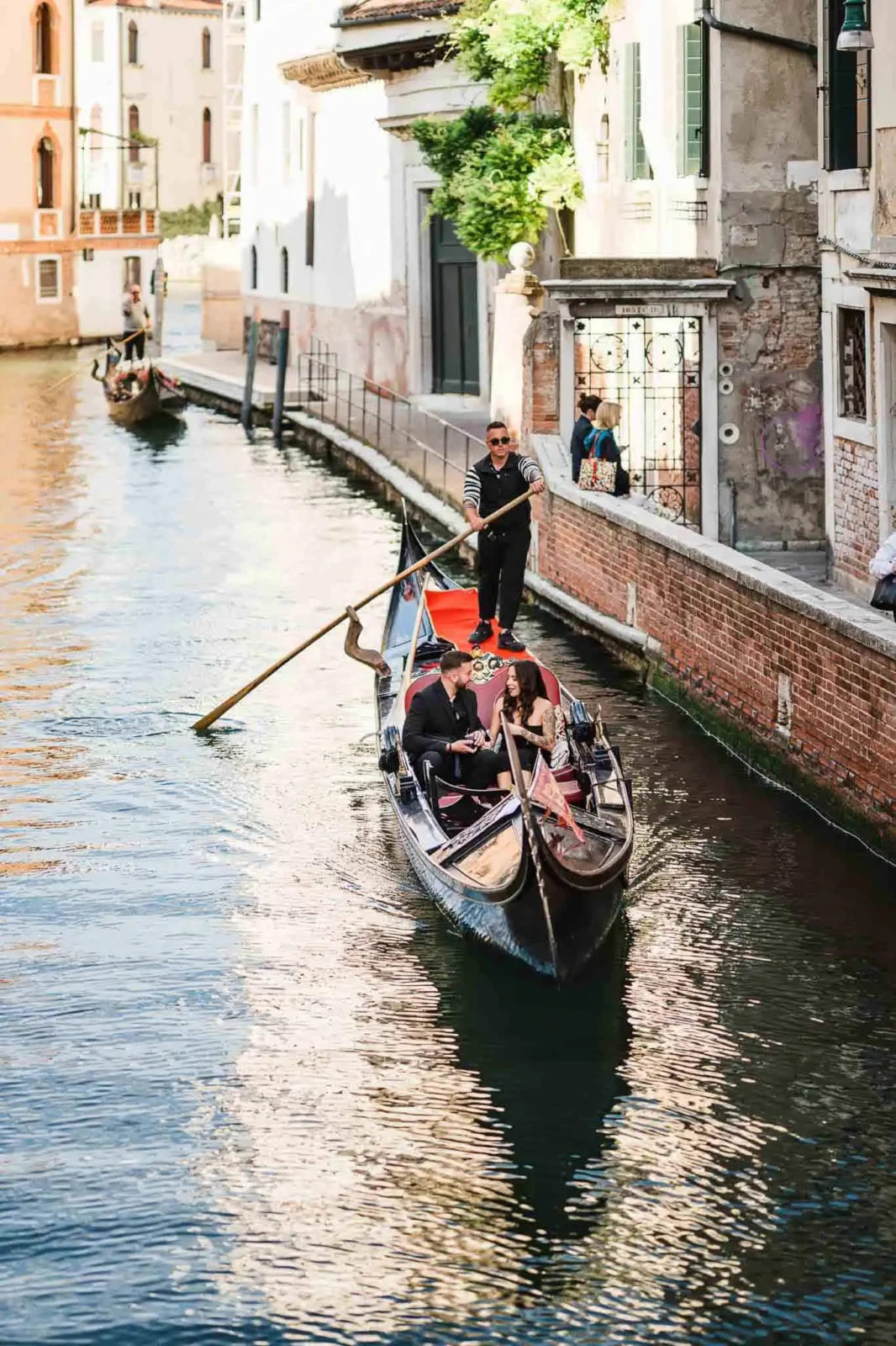 Romantic couple in a gondola in Venice during sunset, perfect for engagement photos.