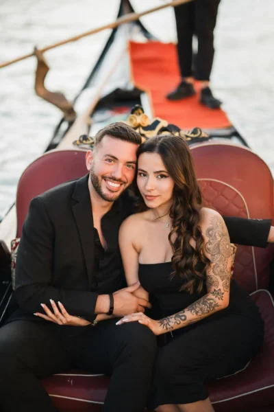 Romantic Venice couple photo on gondola, engagement moment in Italy.