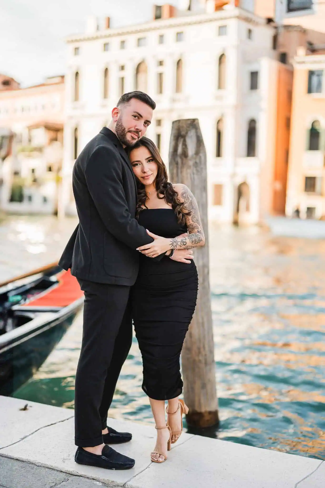 Elegant couple embracing by Venice canal, romantic wedding and proposal photoshoot in Italy.