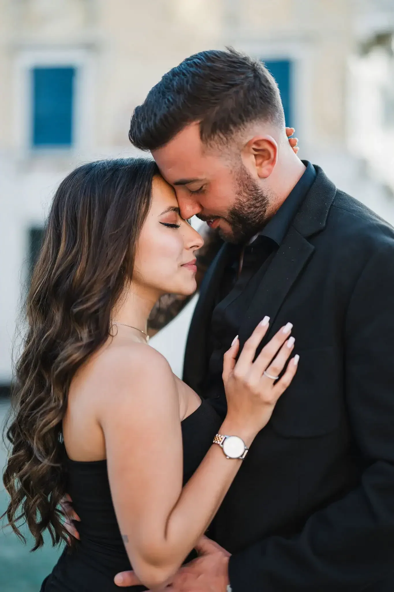 Elegant couple embracing in Venice, capturing romantic proposal moment.