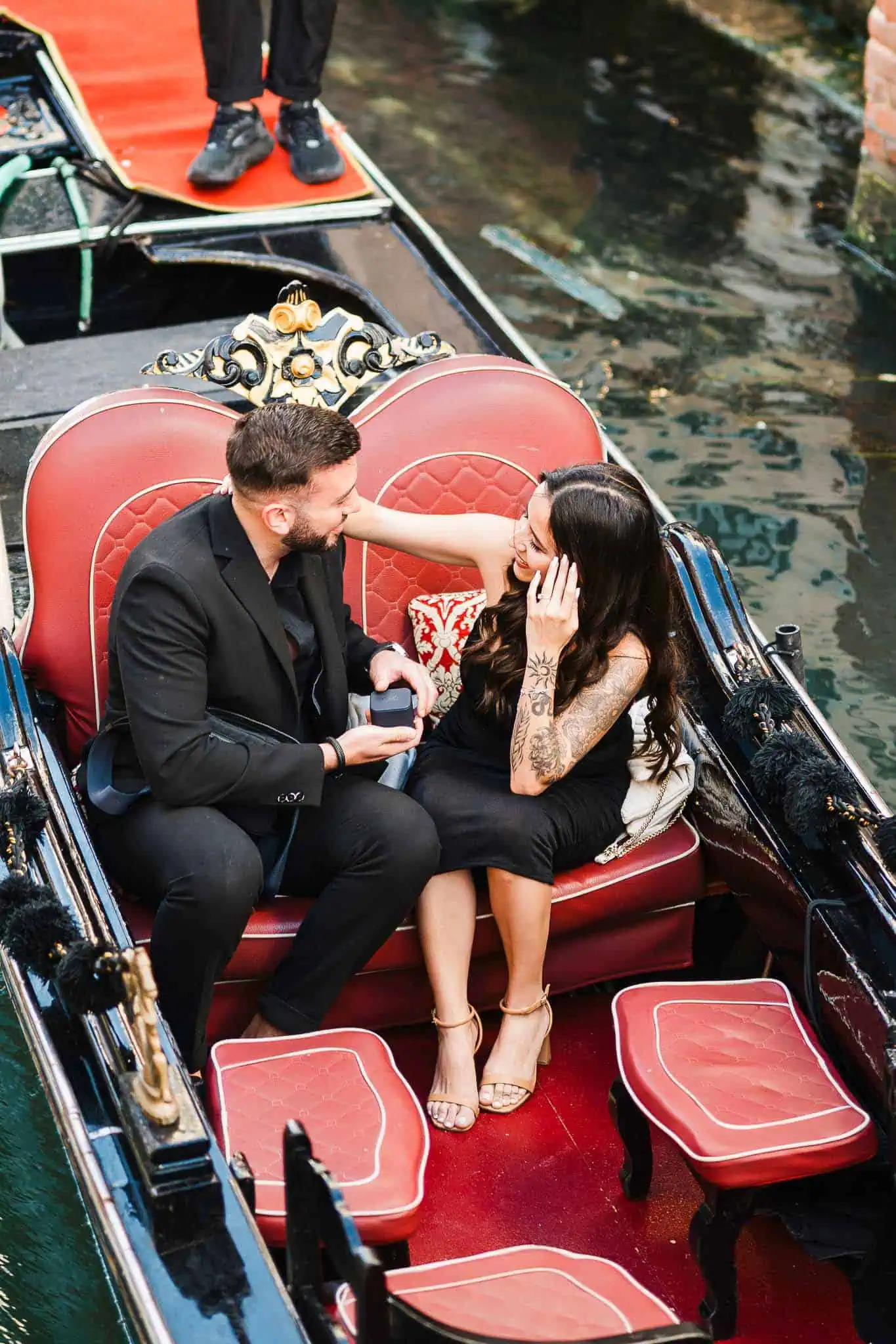 Romantic Venice gondola proposal with couple enjoying a special moment on a classic boat.