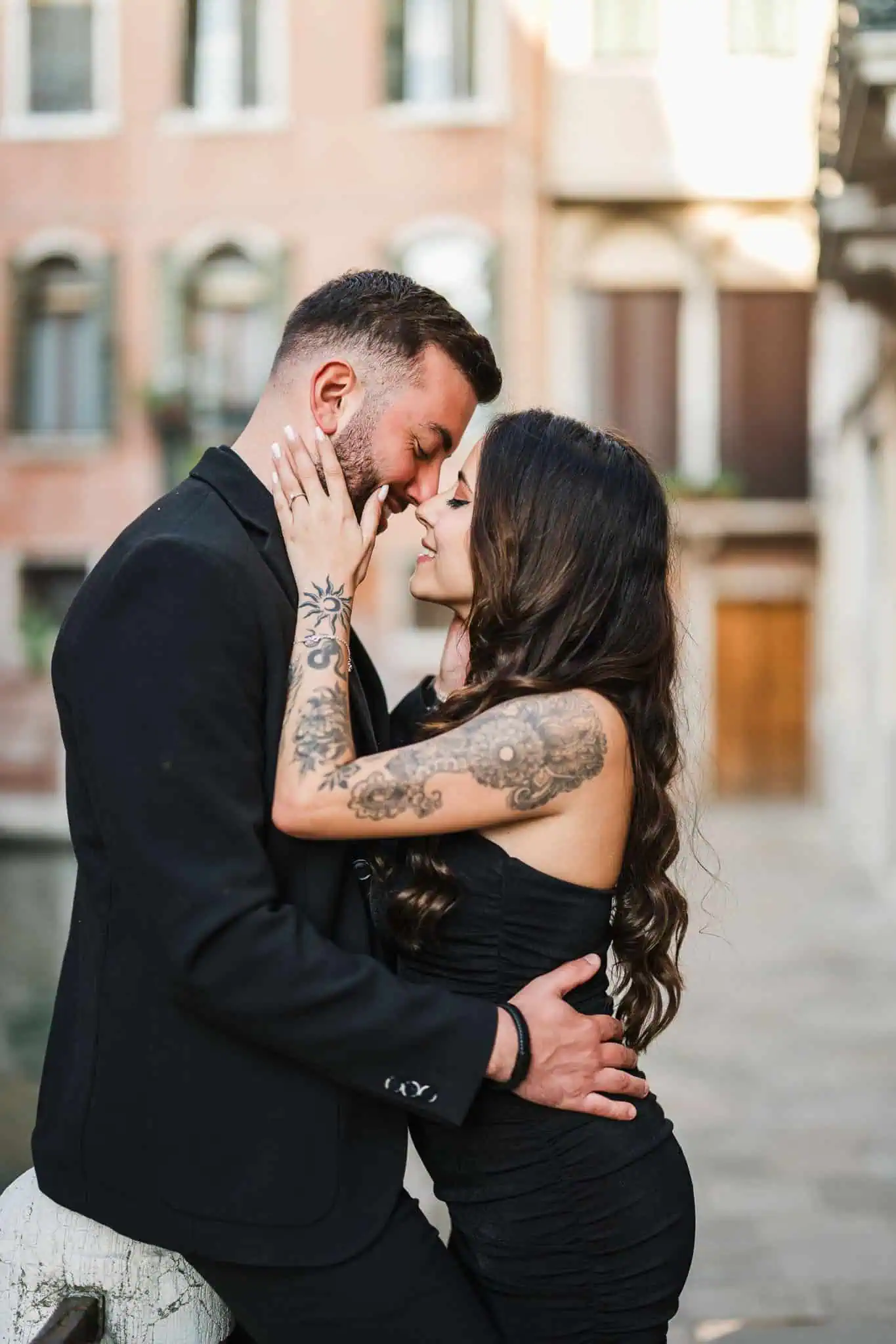 1. Intimate Venice engagement photo of couple embracing by canal.