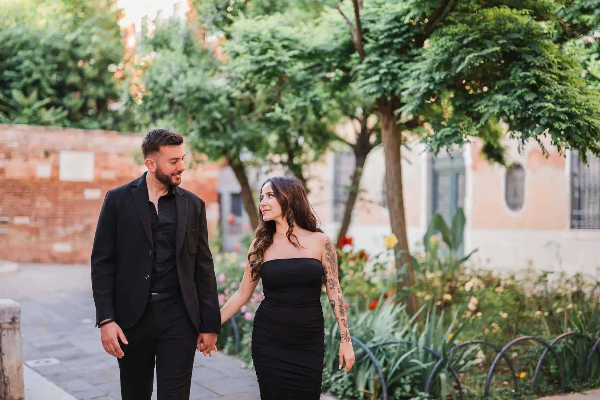 1. Romantic couple walking hand in hand in Venice during sunset, capturing engagement photos.