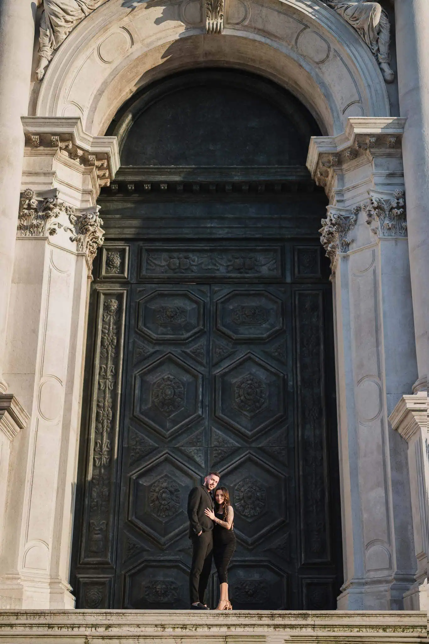 Elegant couple posing in front of historic Venice architecture, perfect for wedding and engagement photographer.