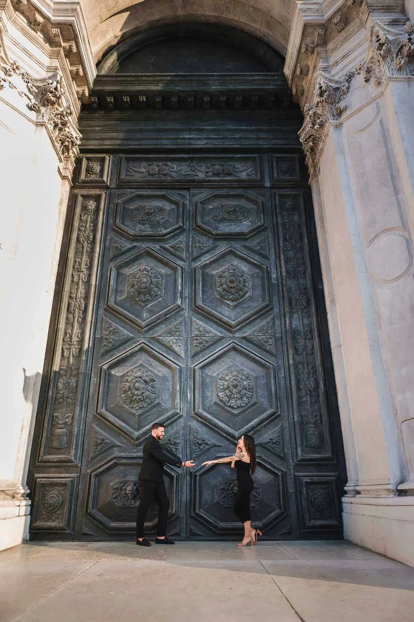 Magnificent Venice wedding proposal beside historic grand door.