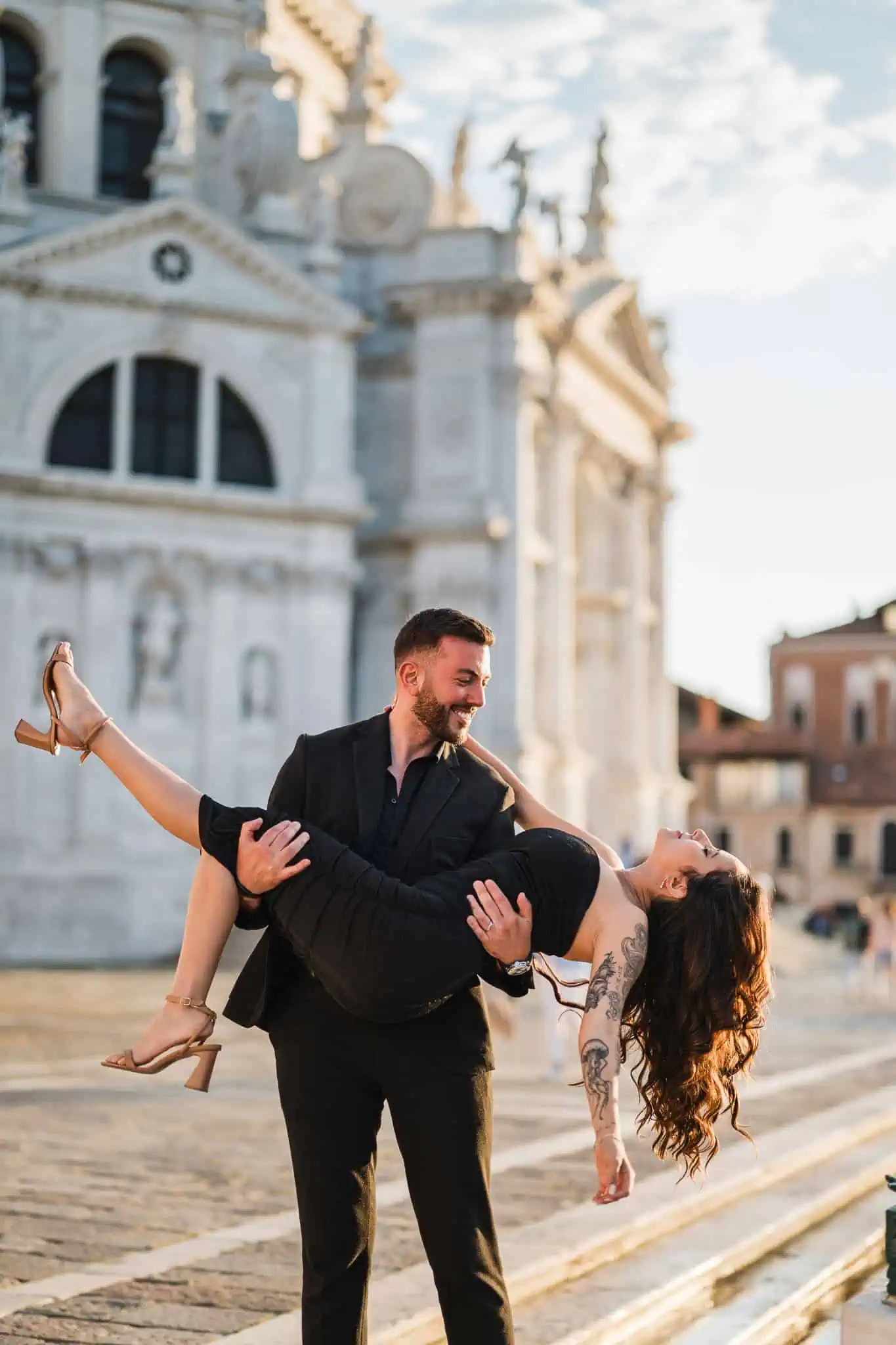 1. Romantic couple in Venice, with a historic church in the background.