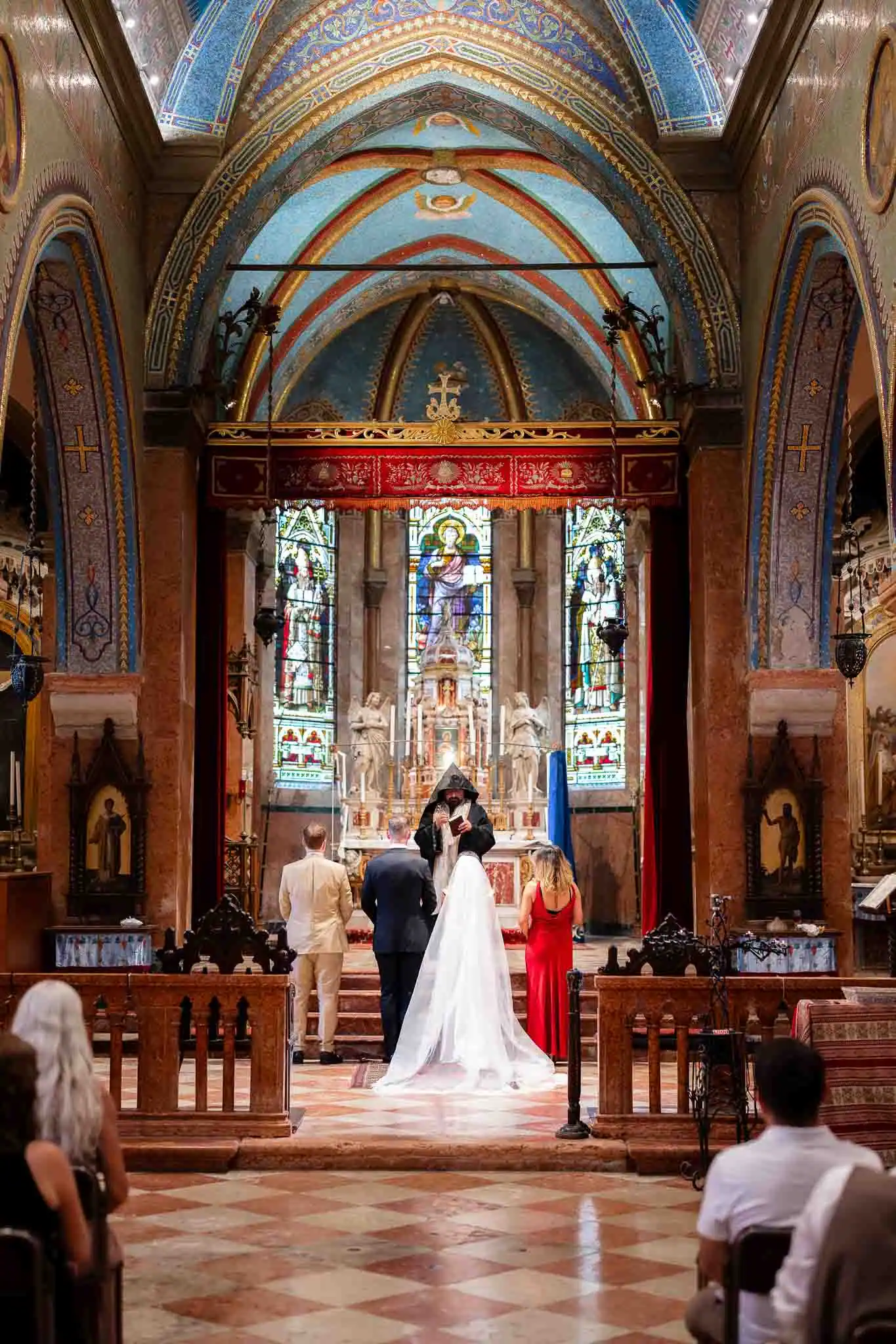 Elegant Venice church wedding ceremony with bride, groom, and officiant.