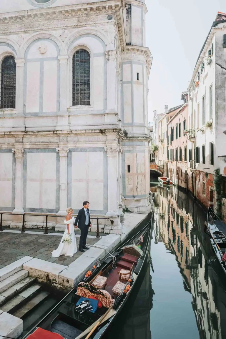 1. Romantic Venice wedding scene with couple by canal and historic architecture.