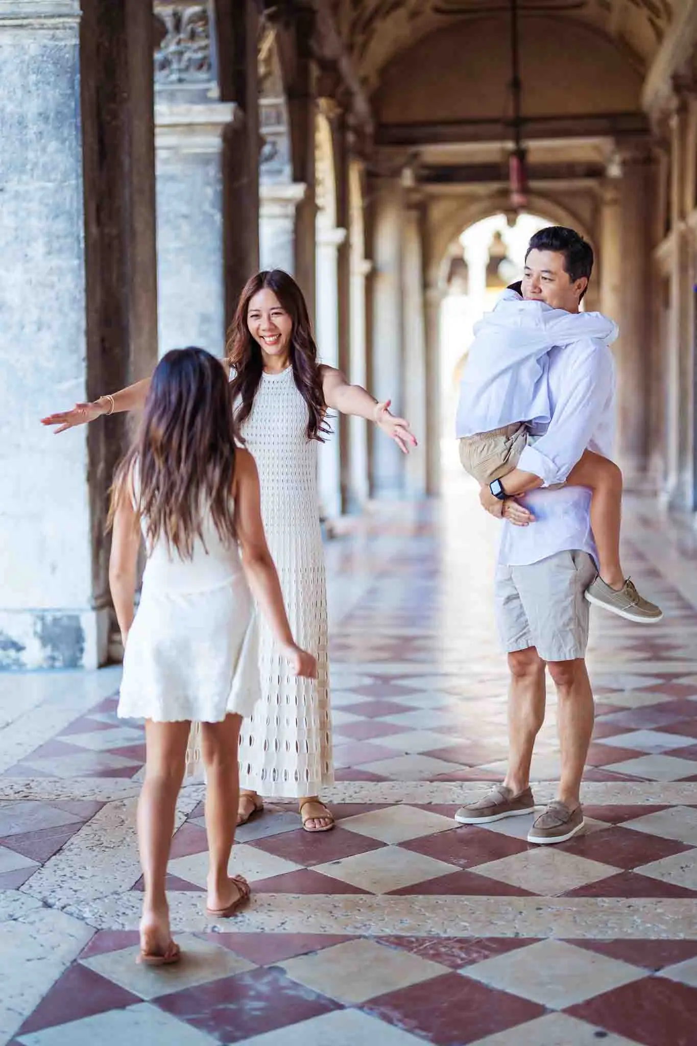 1. Happy family enjoying Venice arches and historic architecture during vacation.