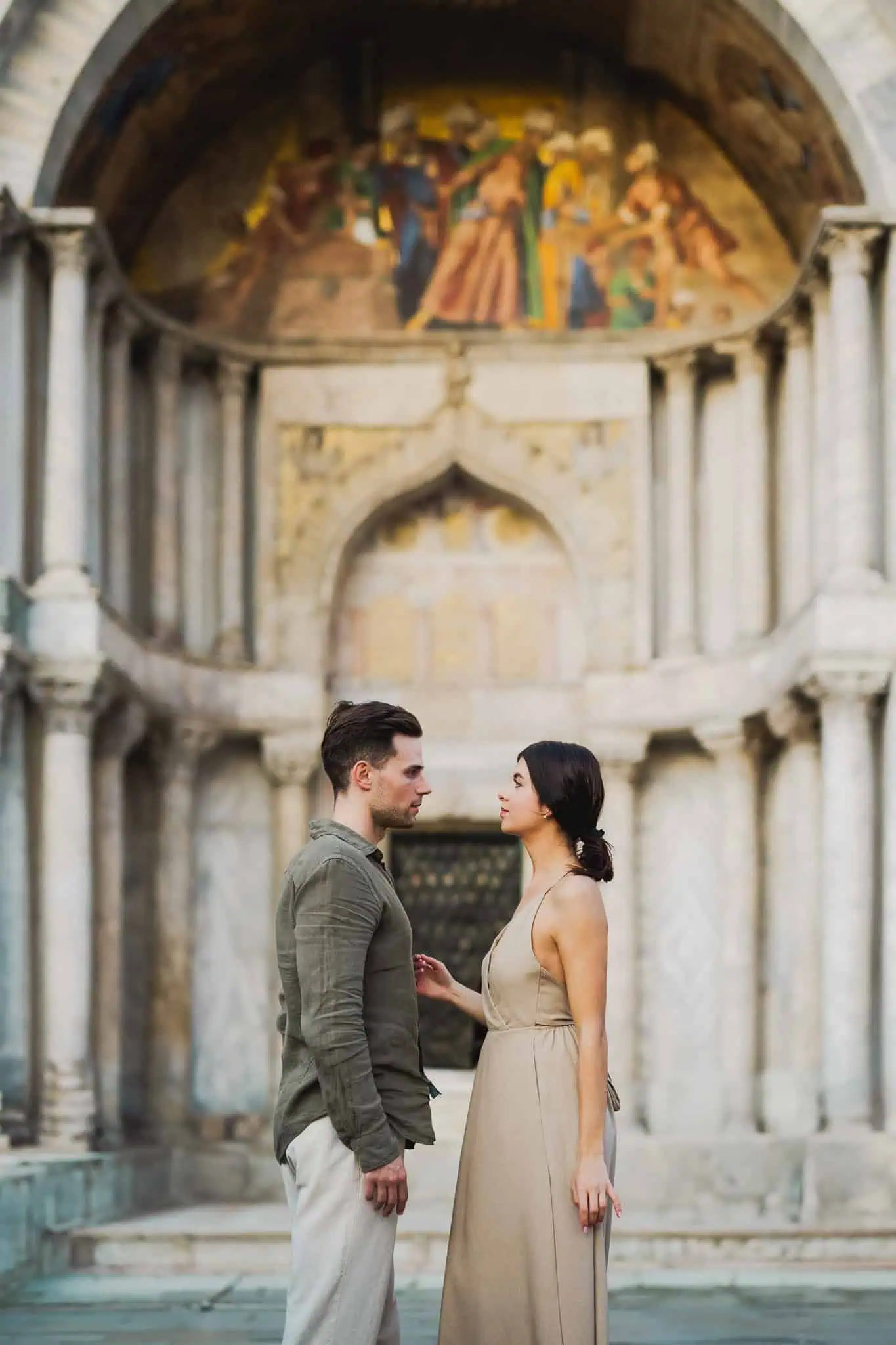 1. Romantic couple in Venice with historic architecture backdrop.
