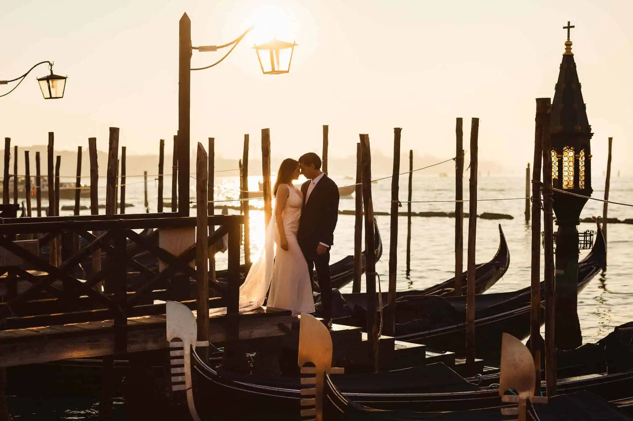 Romantic Venice gondola wedding proposal at sunset, couple embracing on a gondola with historic city backdrop.