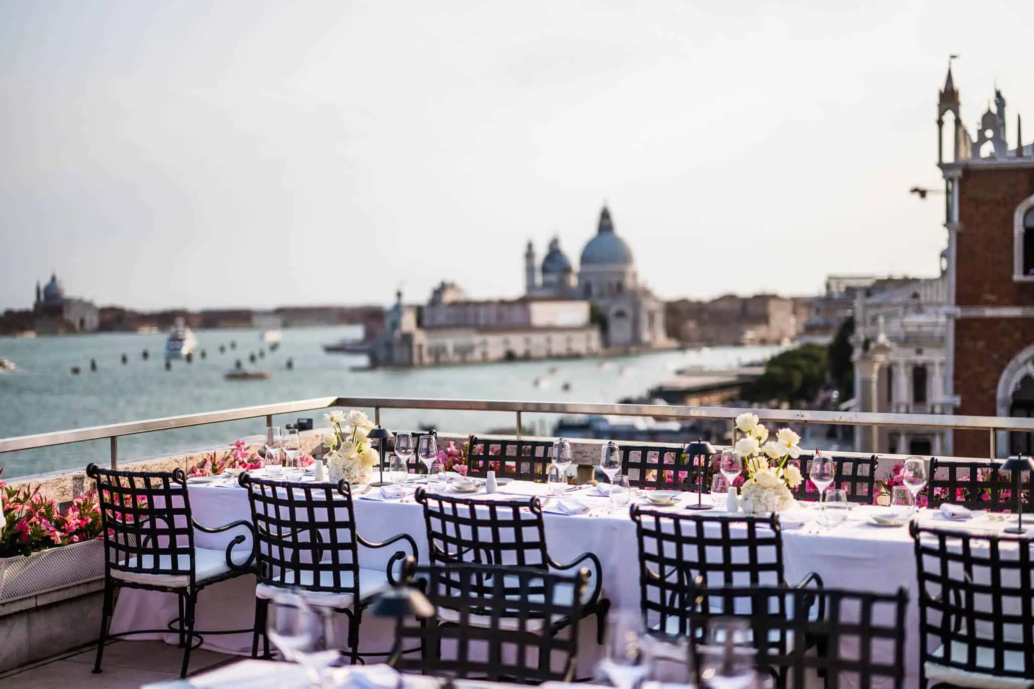 Elegant Venice rooftop wedding reception overlooking canals, with beautifully set tables and historic city views.
