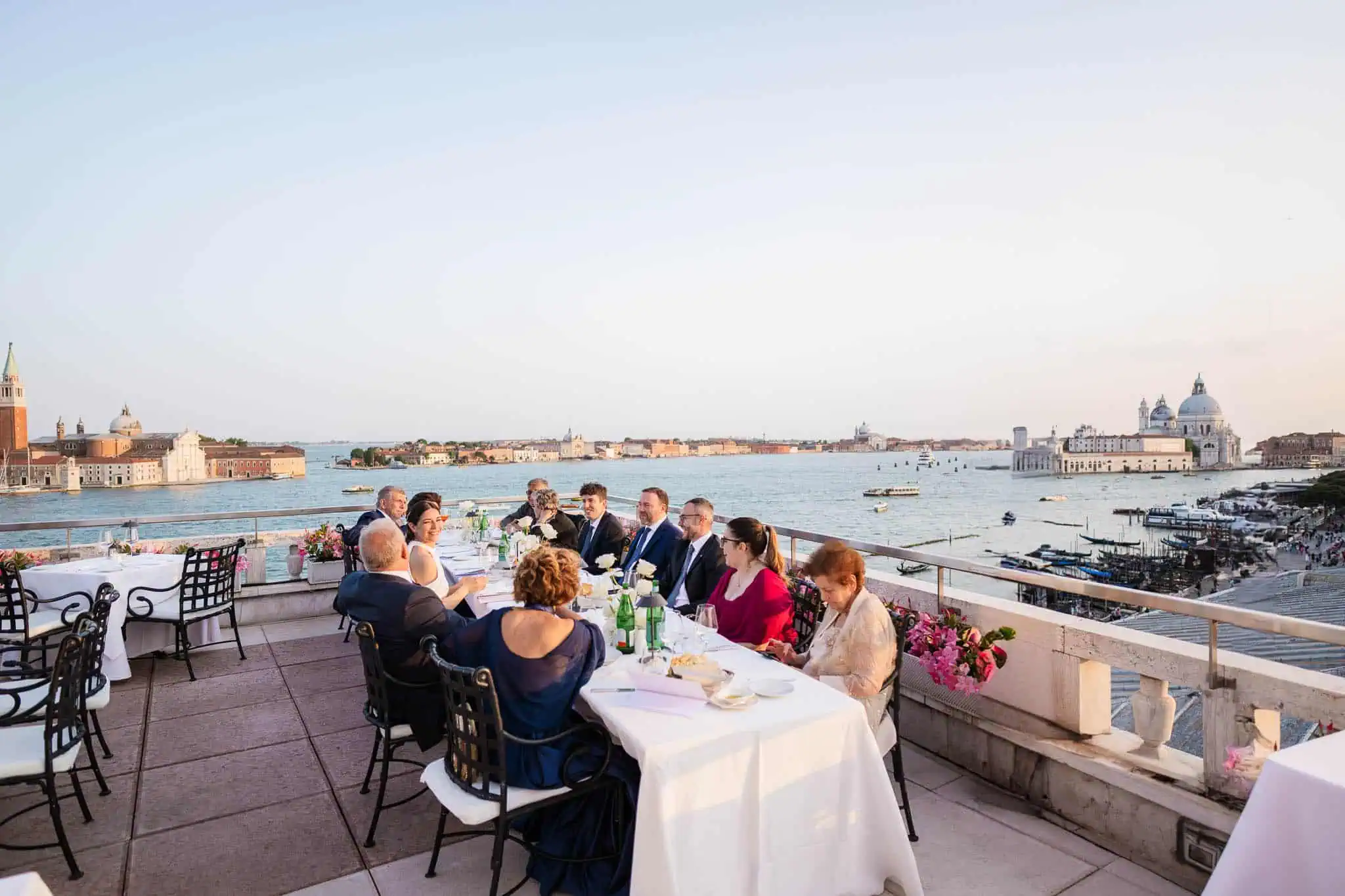 Elegant outdoor wedding celebration on a Venice terrace with city skyline views.