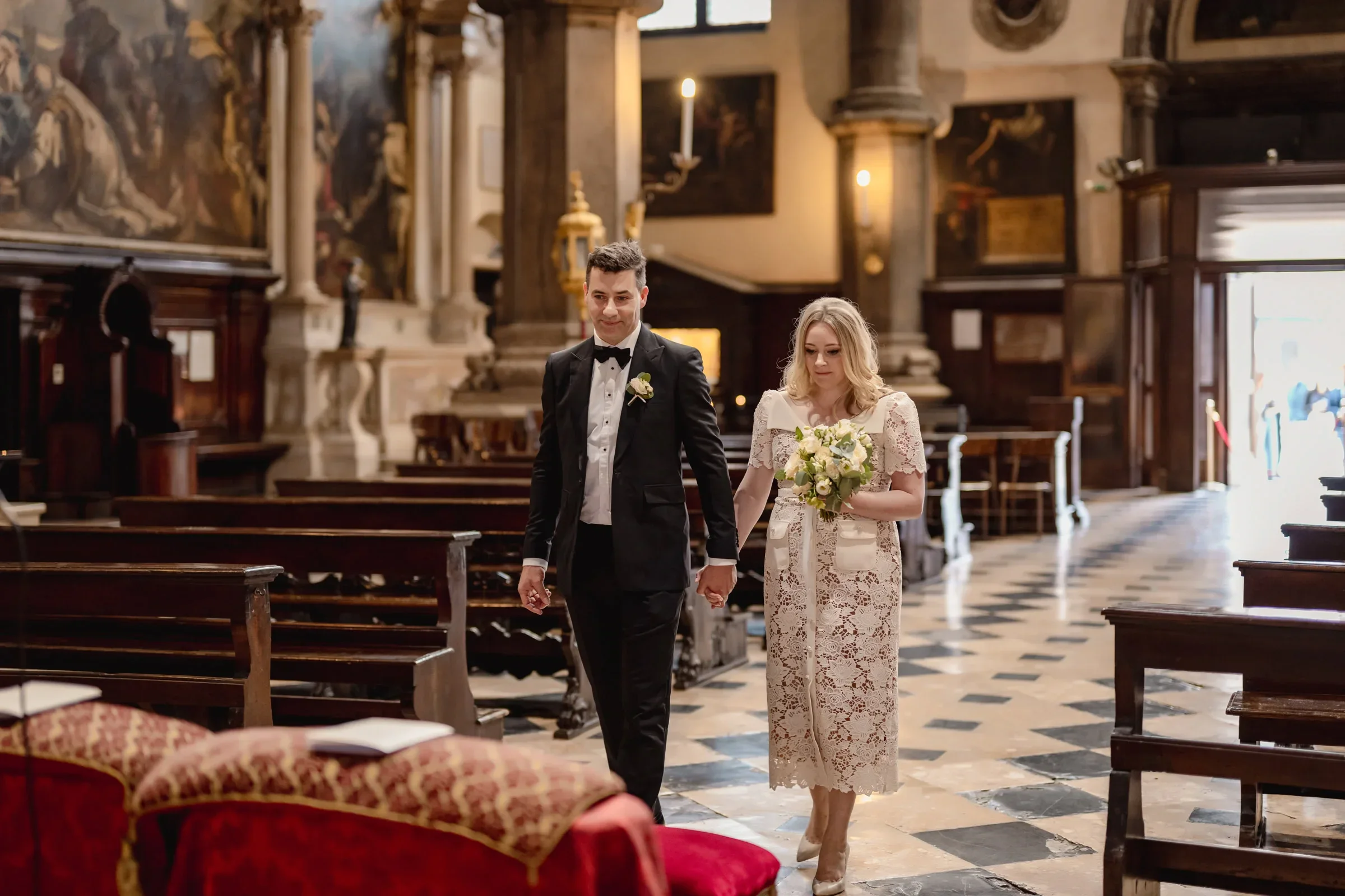 Elegant couple during an intimate ceremony inside a historic church.