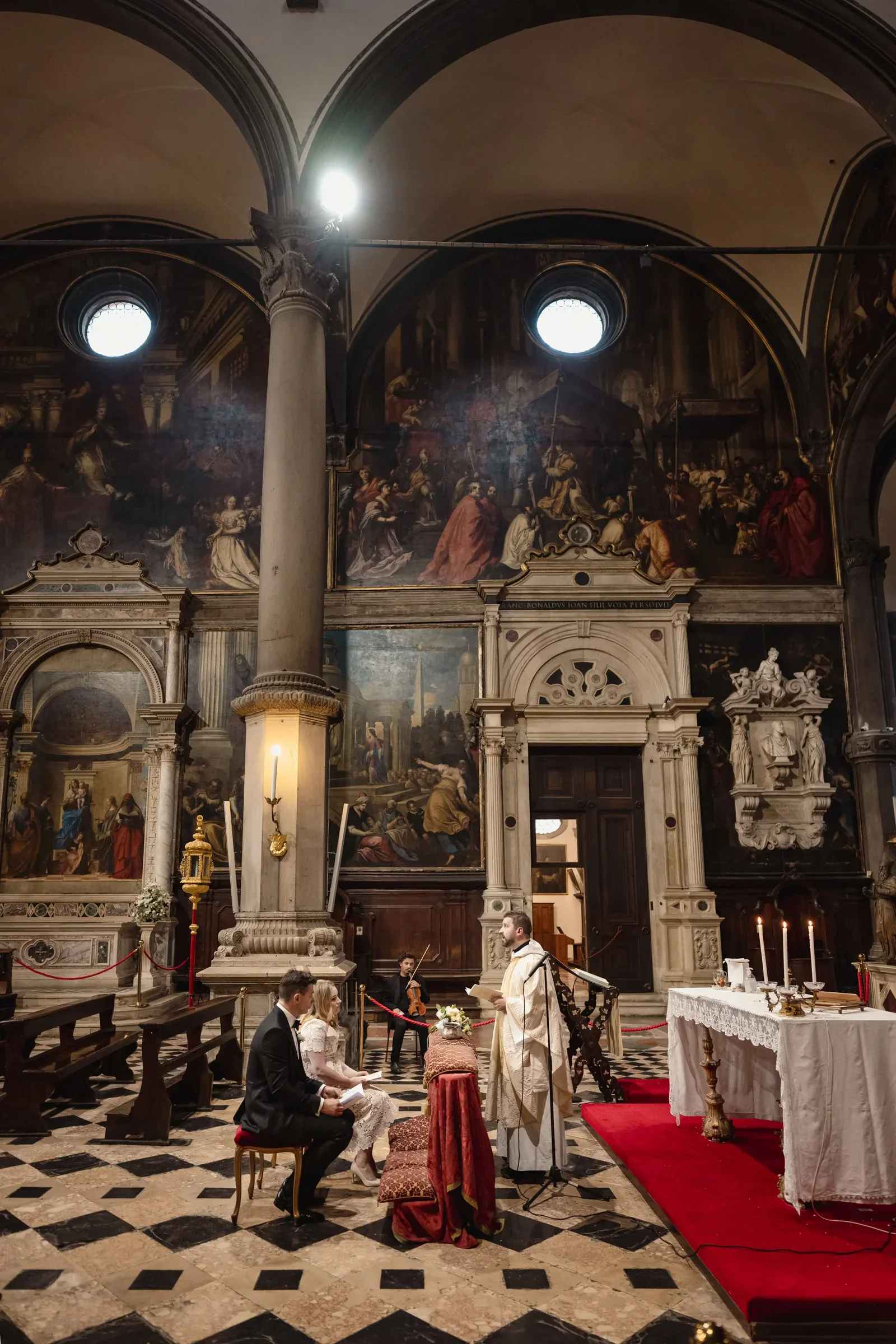 Elegant couple elopement ceremony take place inside a historic church with elaborate murals.