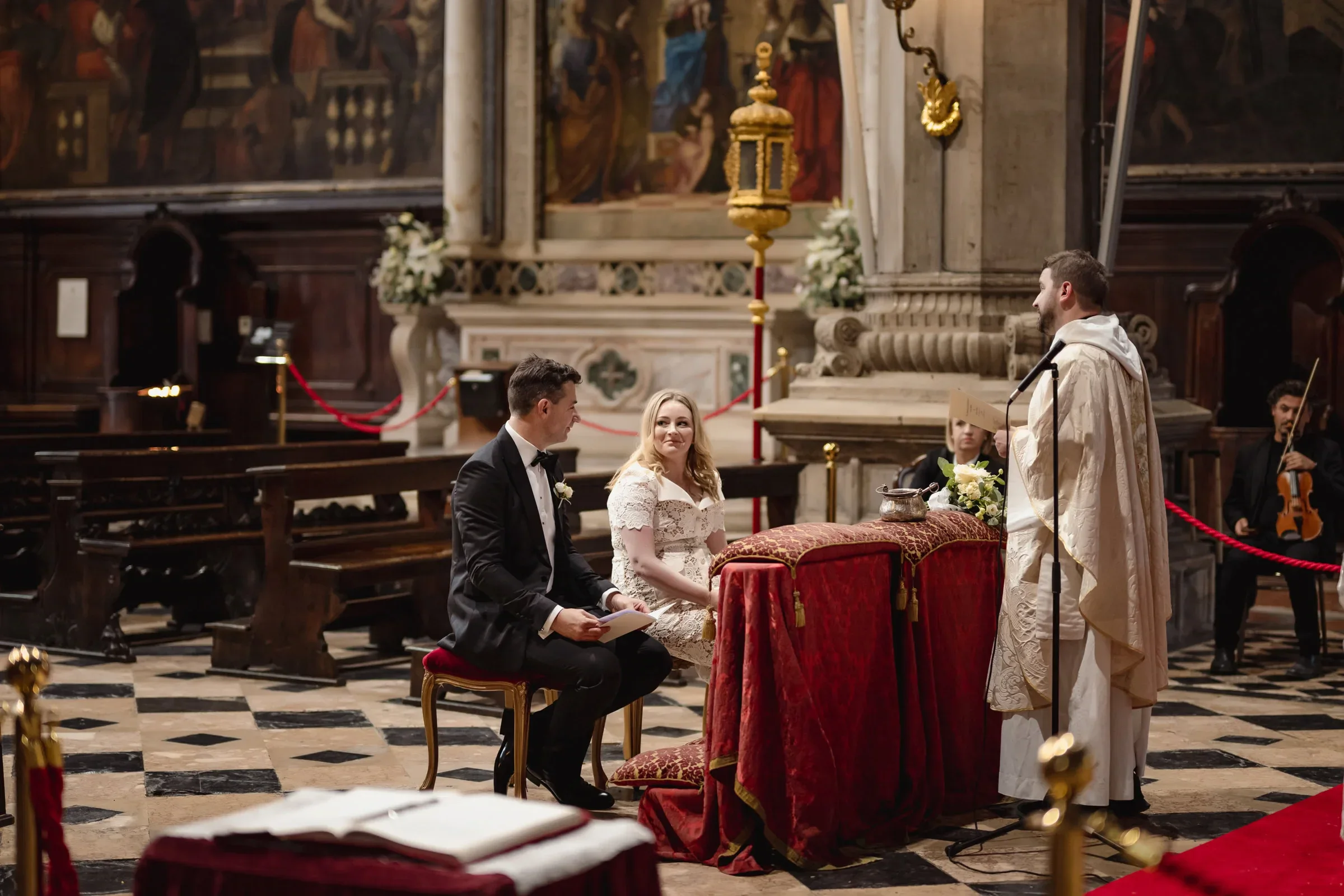 Elegant couple exchanging vows during intimate elopement ceremony inside historic church.