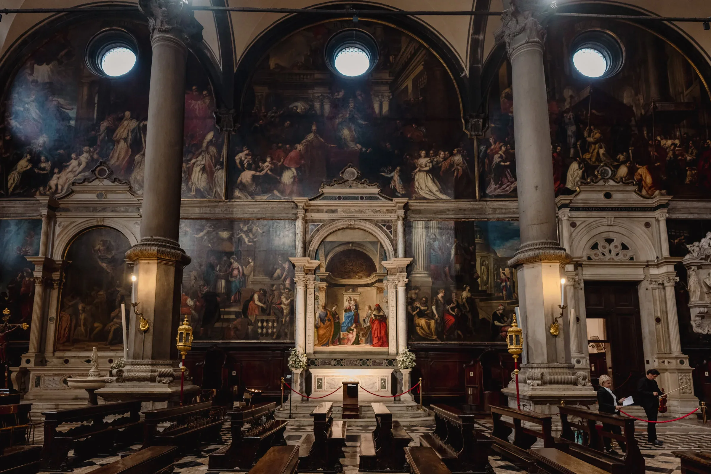 Elegant couple ceremony inside a historic church with intricate murals and grand architectural details.