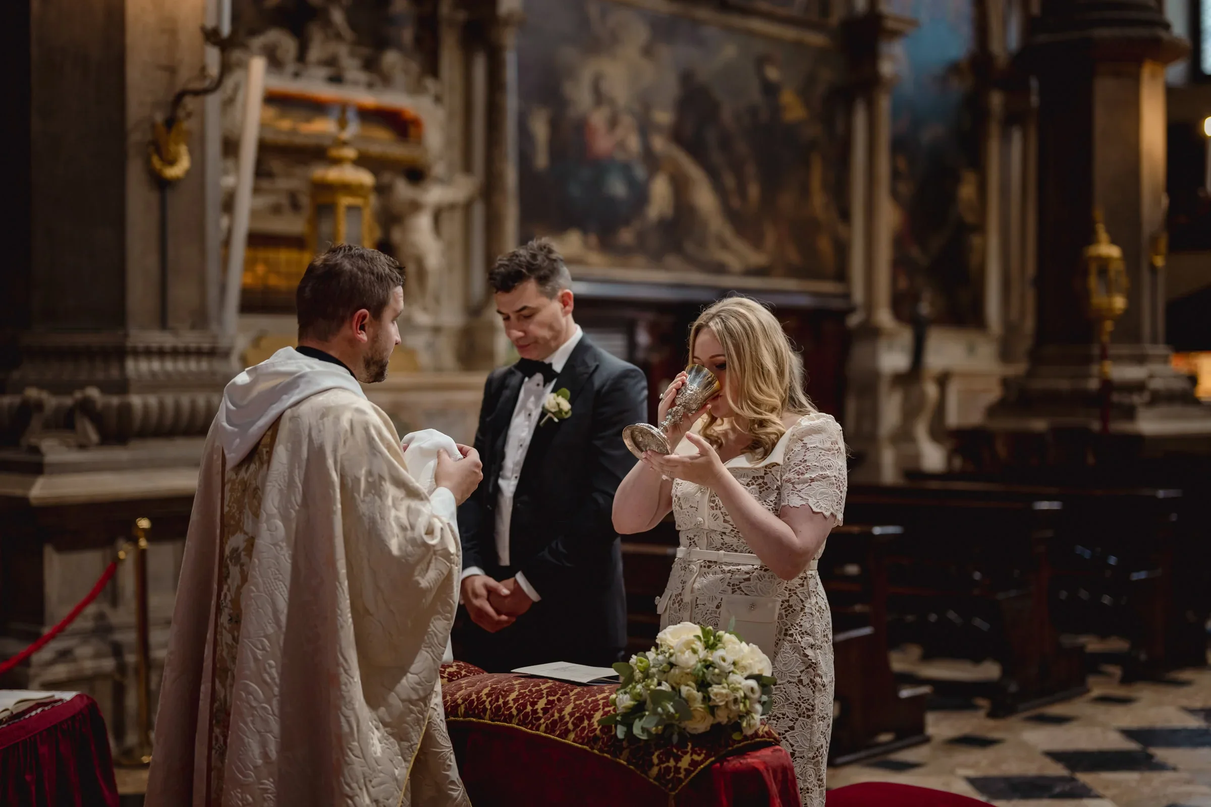 Elegant couple exchange vows during an intimate ceremony in a historic church.