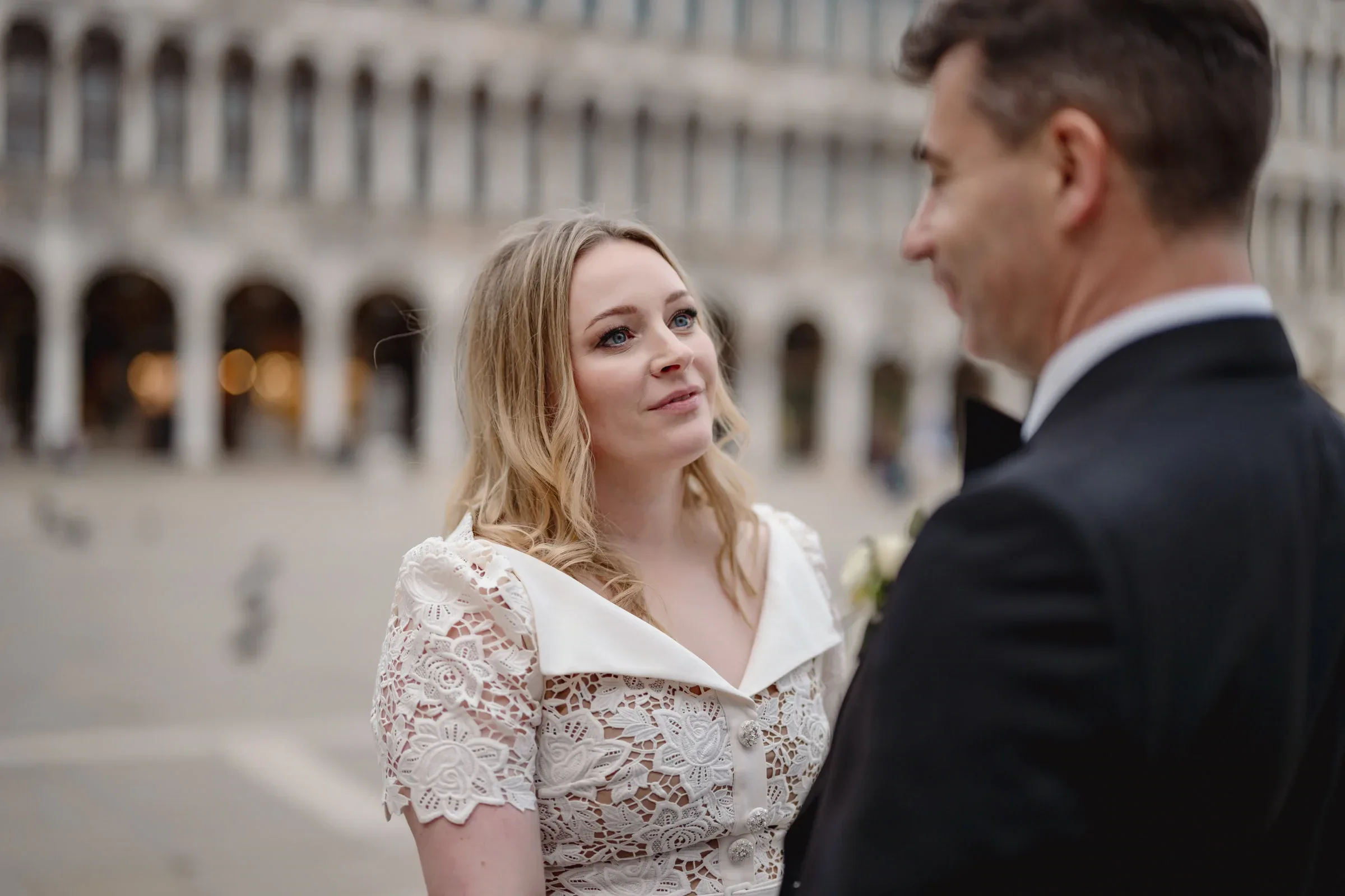 Elegant couple exchanging vows outdoors near the Colosseum, capturing a romantic elopement moment.