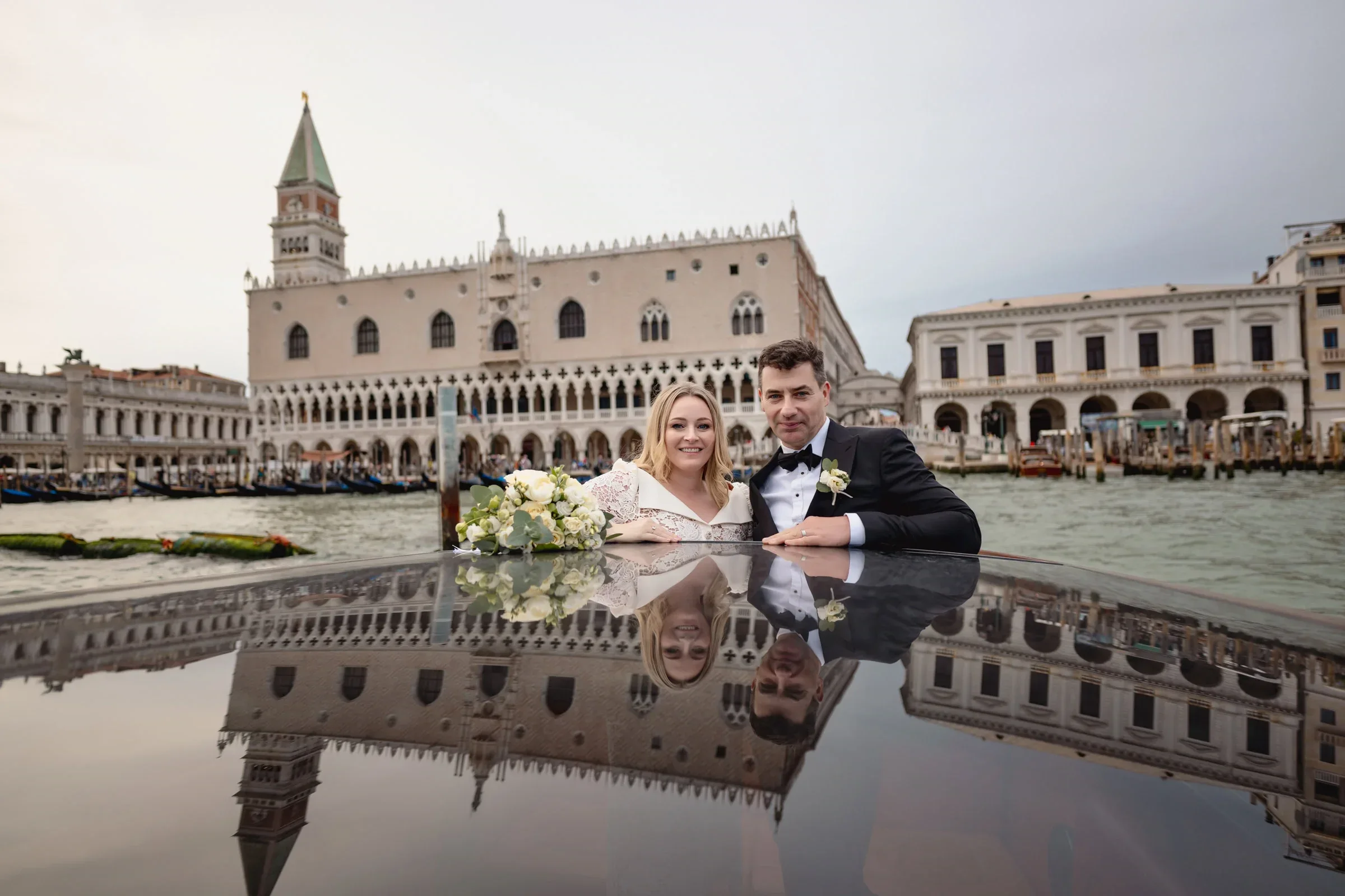 Elegant couple enjoying a romantic moment on a boat in Venice.