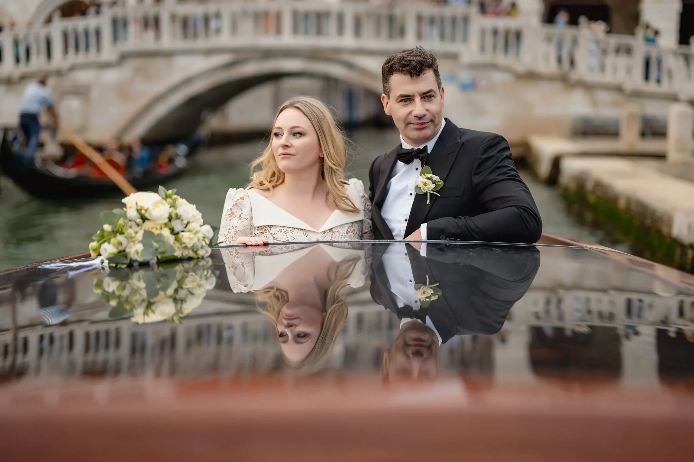Elegant couple during an intimate elopement on a romantic gondola ride in Venice.