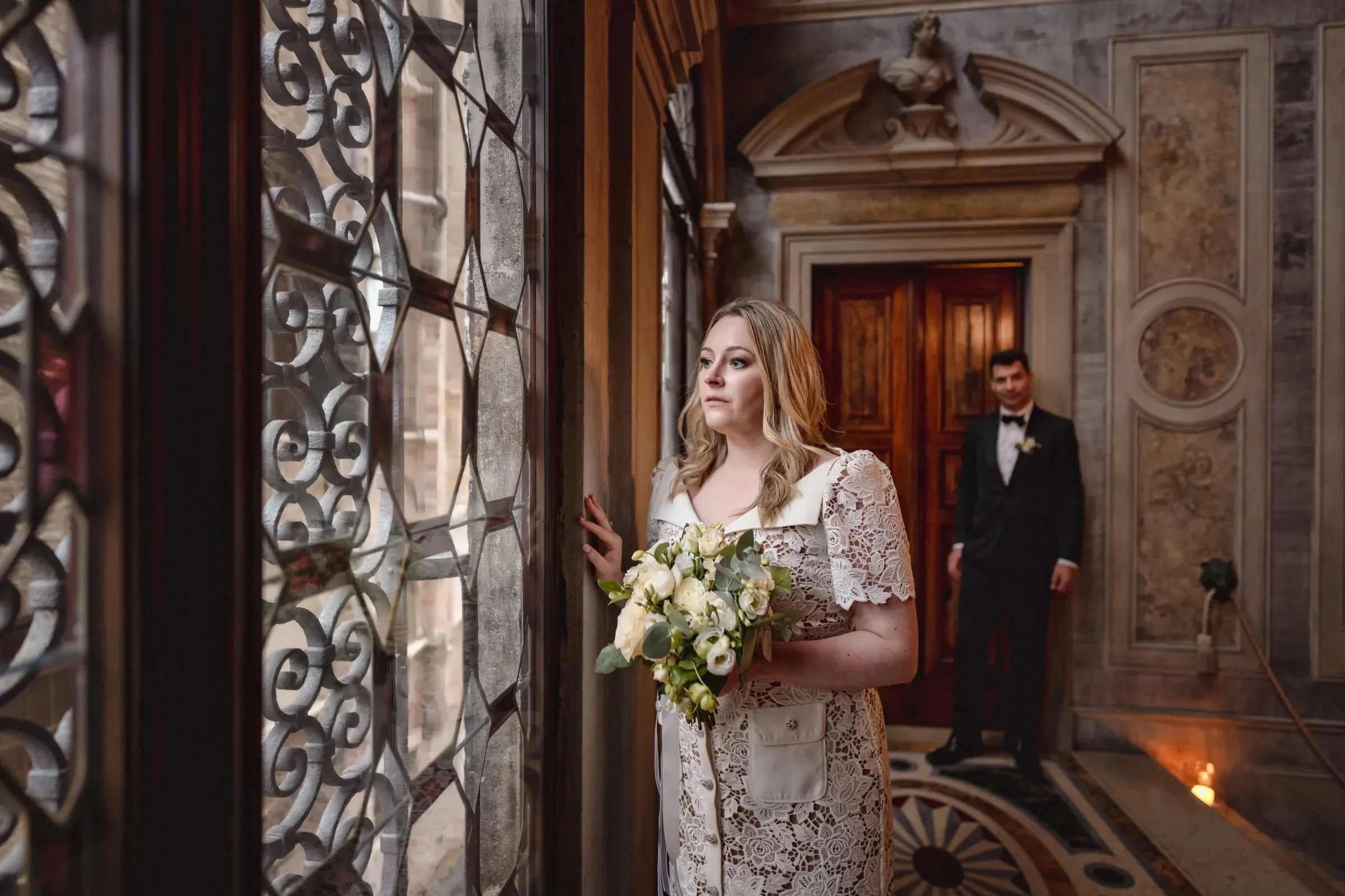 Elegant couple during an intimate elopement in a historic, ornate interior setting.