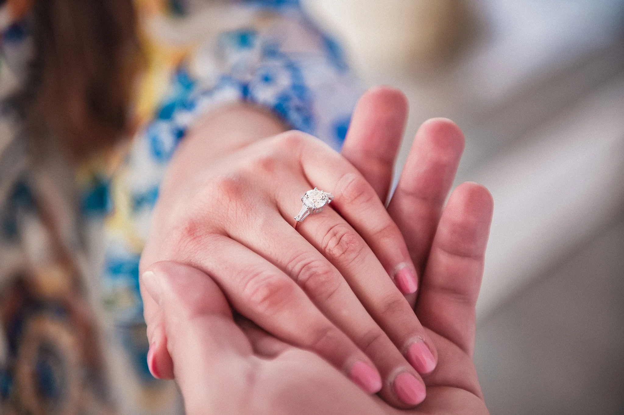 Elegant engagement ring on woman's hand in Venice wedding photo shoot.