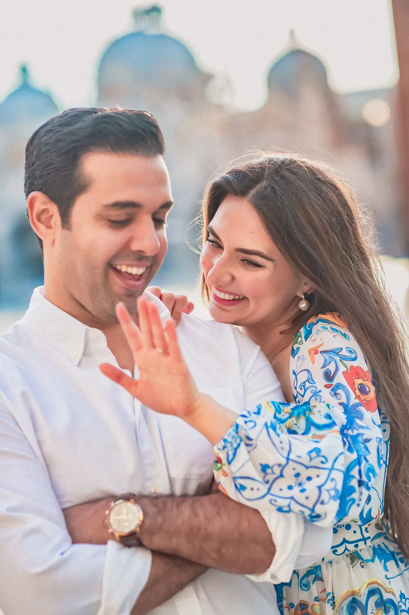 Happy couple enjoying romantic moment in Venice, Italy, for engagement photos.