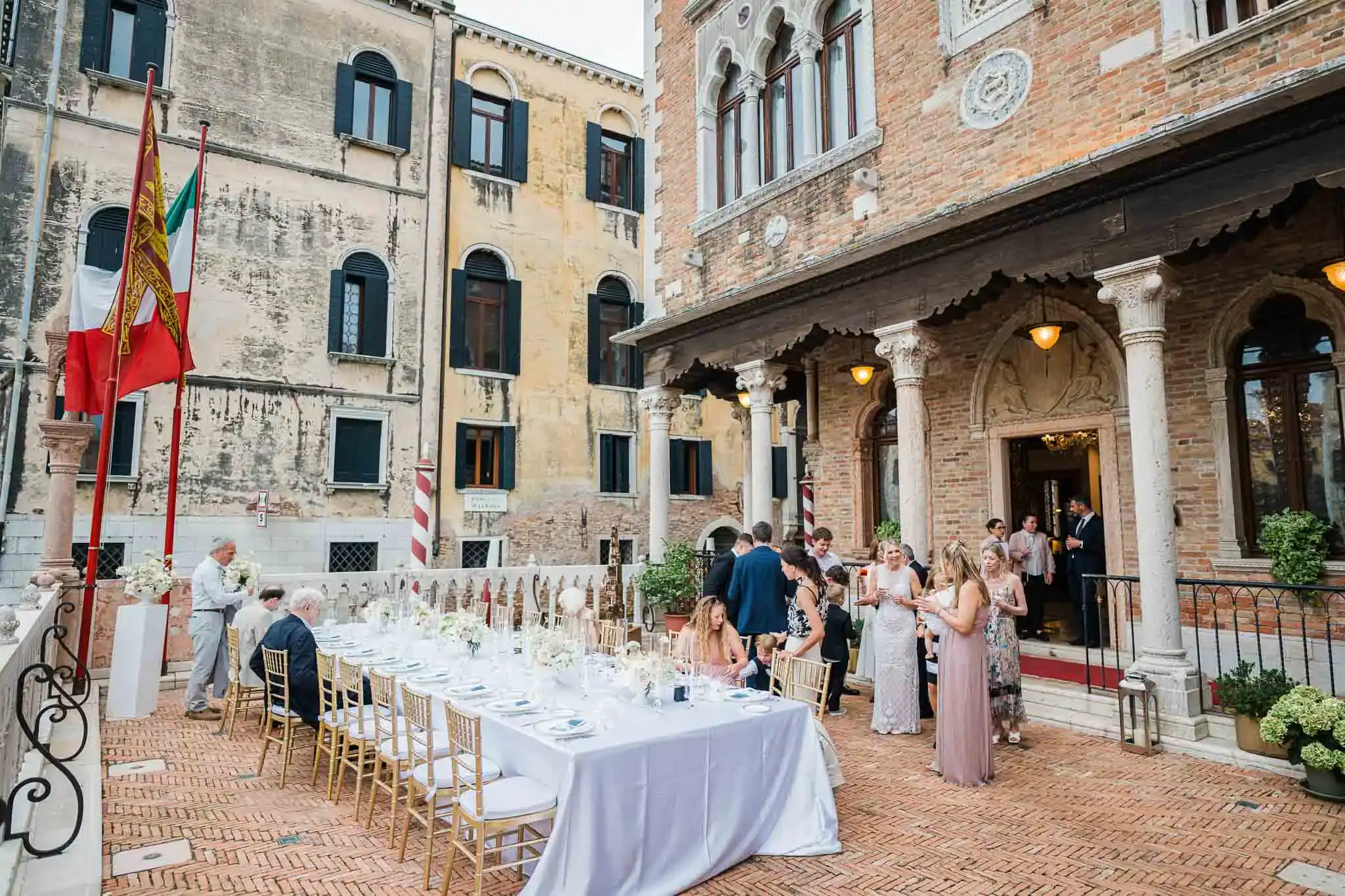 Elegant Venice wedding reception with historic architecture and guest gathering.