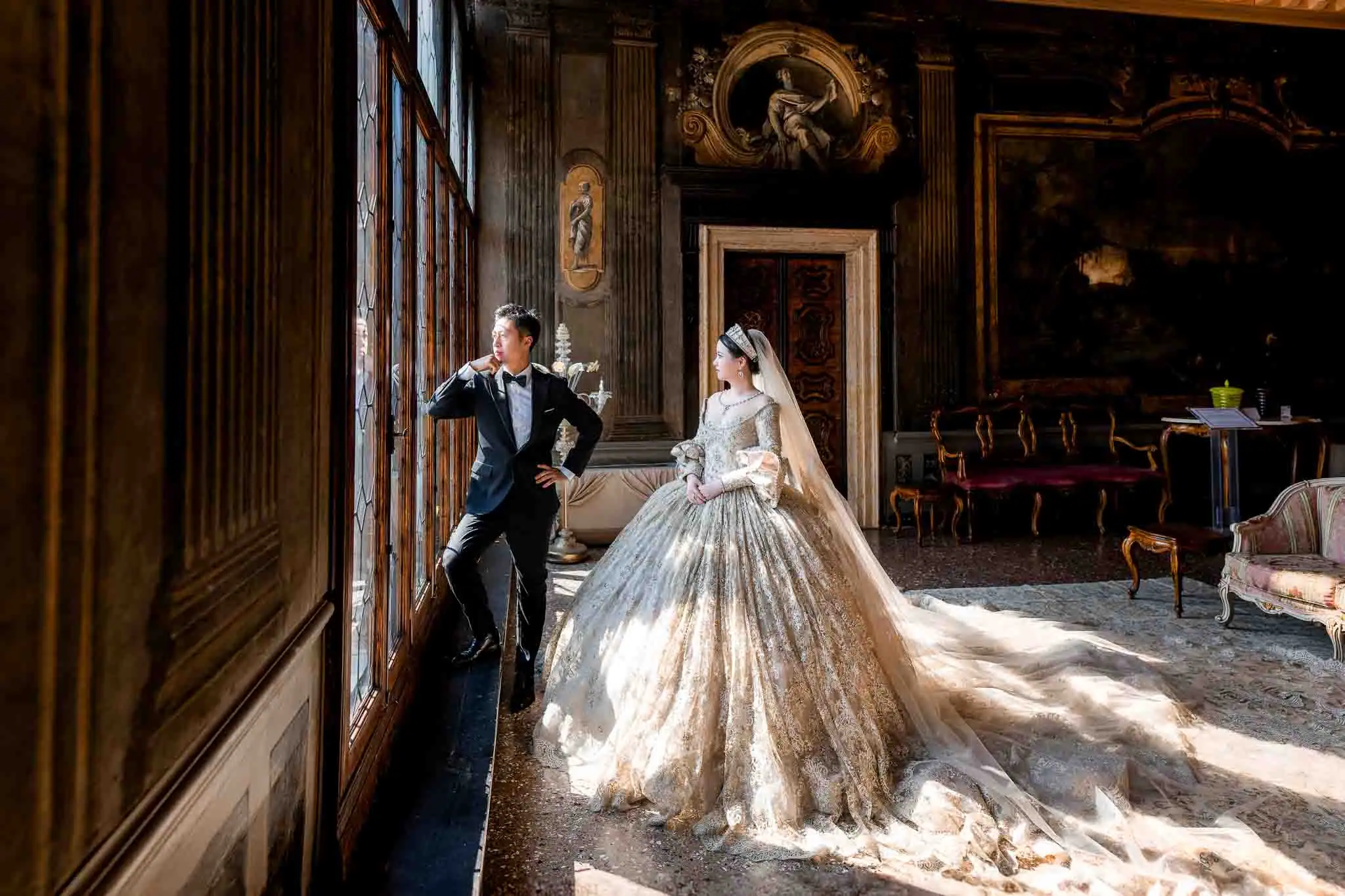 Elegant wedding couple portraits in luxurious Venetian interior with natural sunlight.