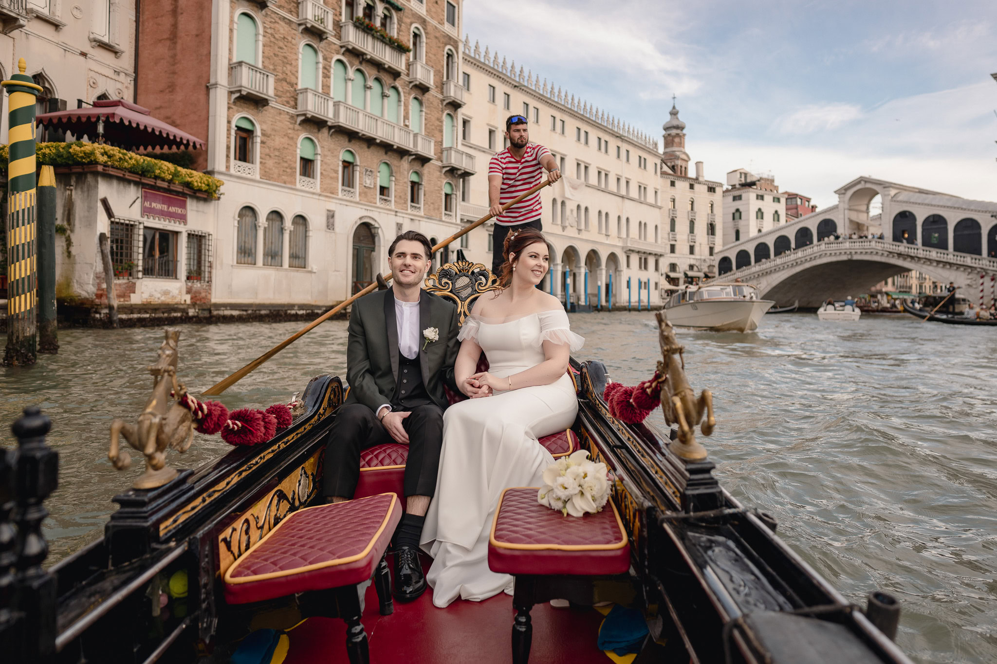 Couple on a gondola in Venice with Ca’ Sagredo Palace in the background.