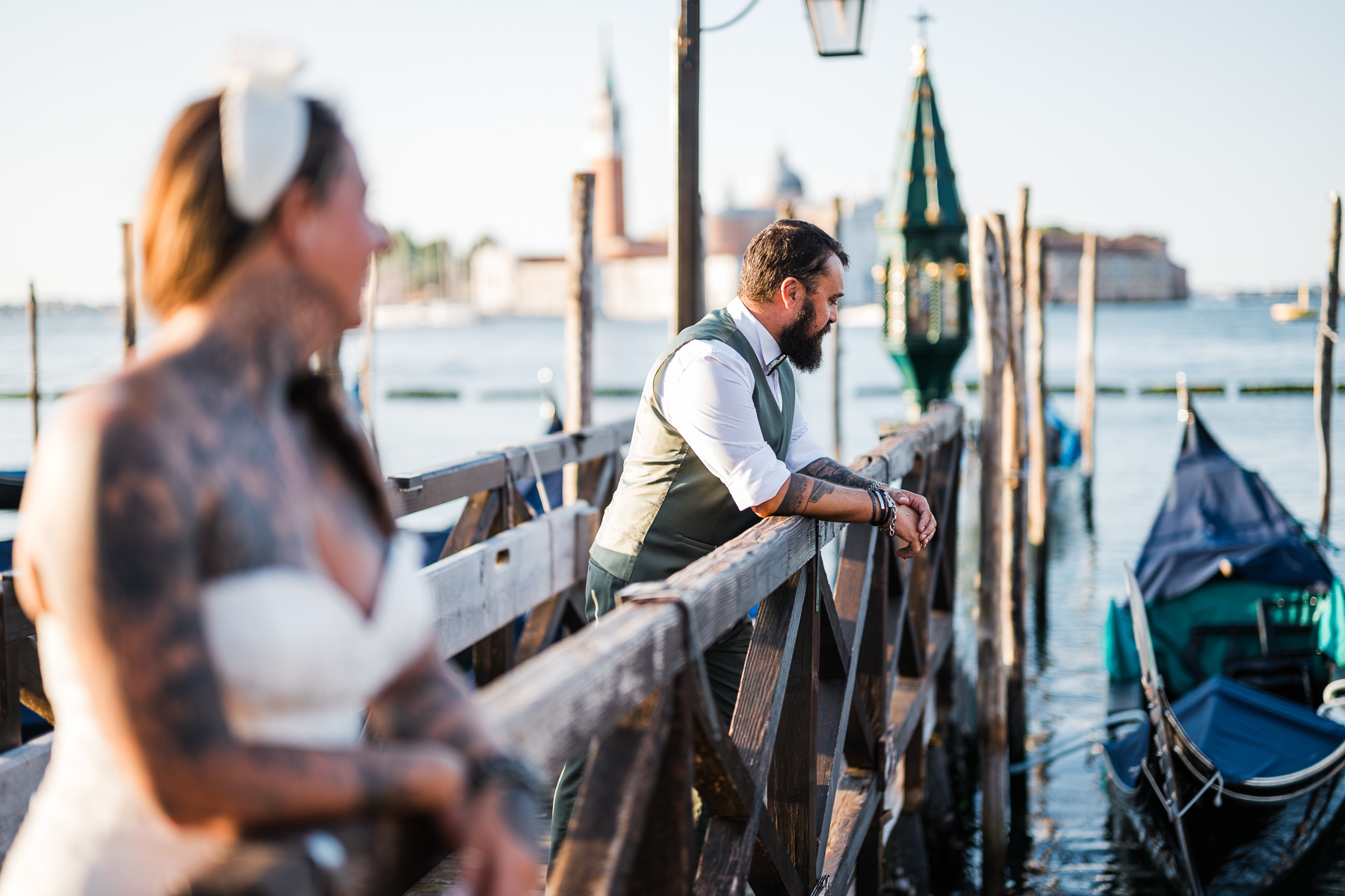 Romantic couple on Venice dock at sunrise, early morning light, quiet and intimate atmosph.