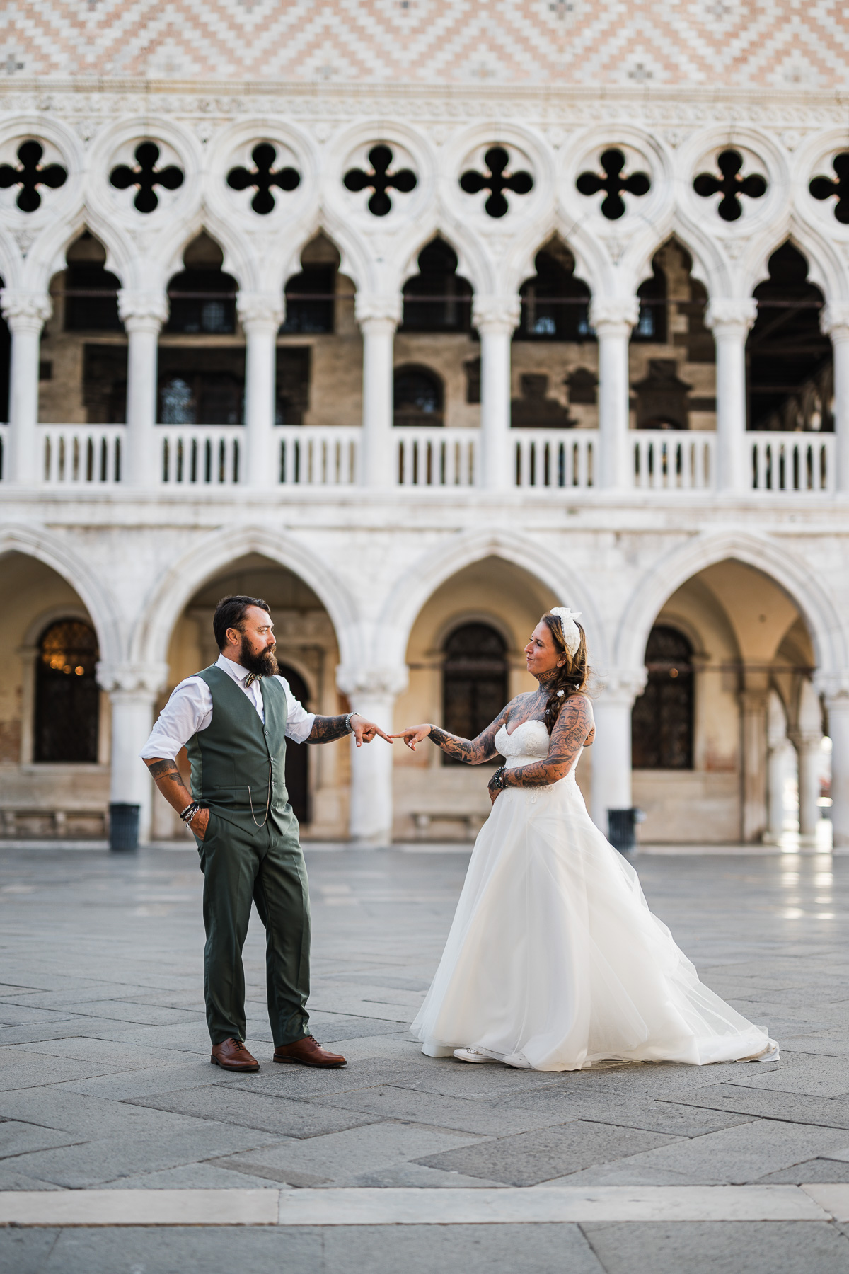 Romantic couple exchanging vows in Venice's historic Piazza San Marco at dawn.