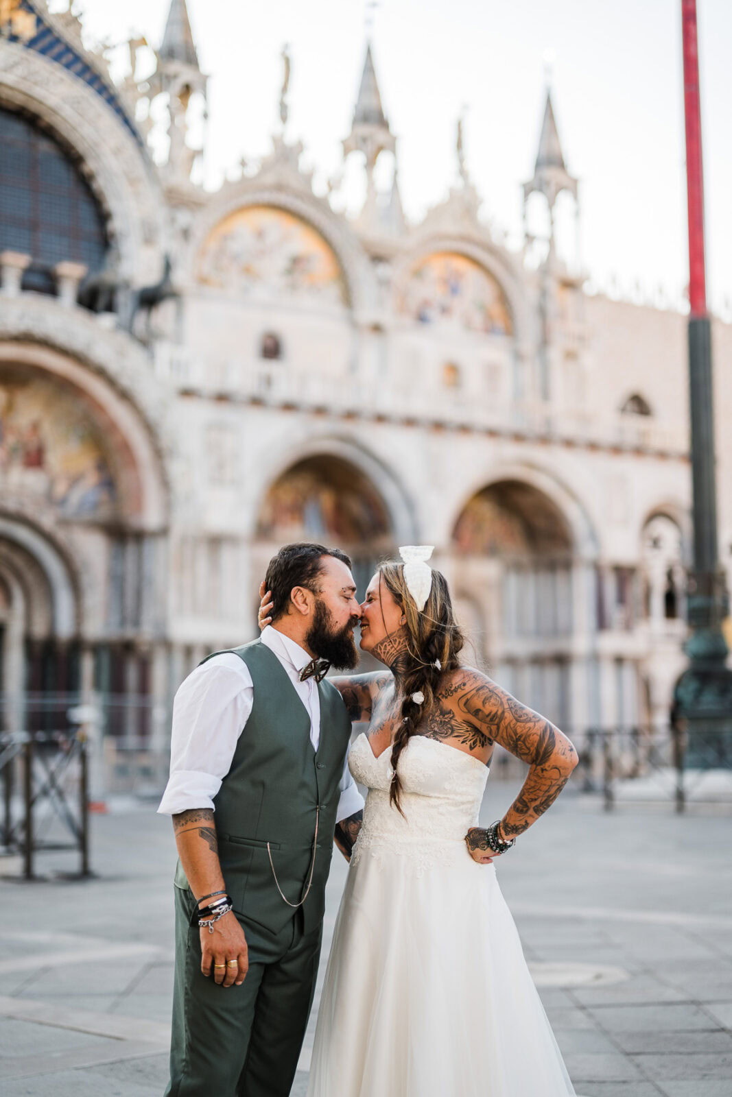 Venice couple sharing a tender moment near St. Mark’s Basilica at dawn, soft light and qui.