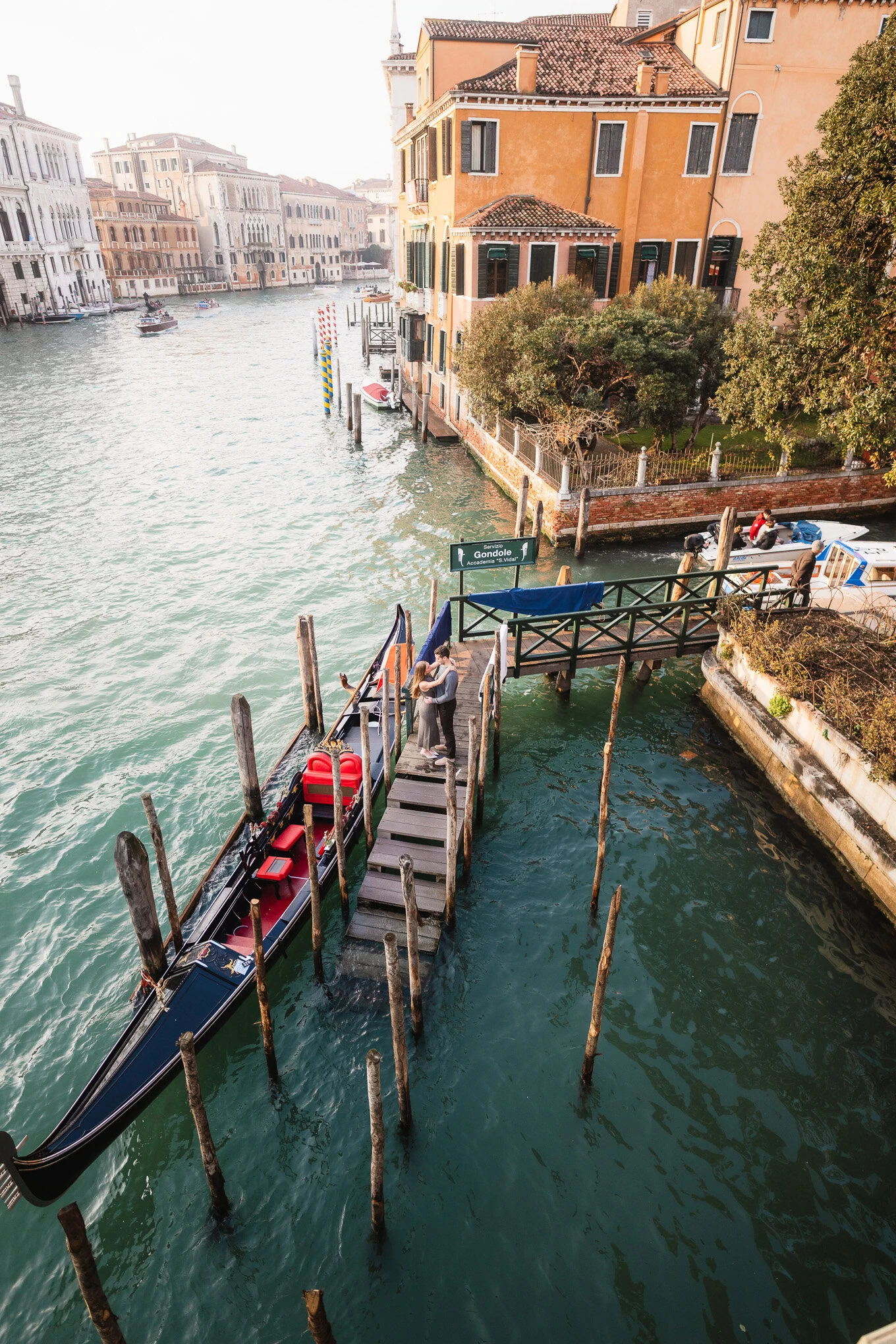 A serene scene of gondolas docked along a quiet canal in Venice, bathed in warm, soft light with his.