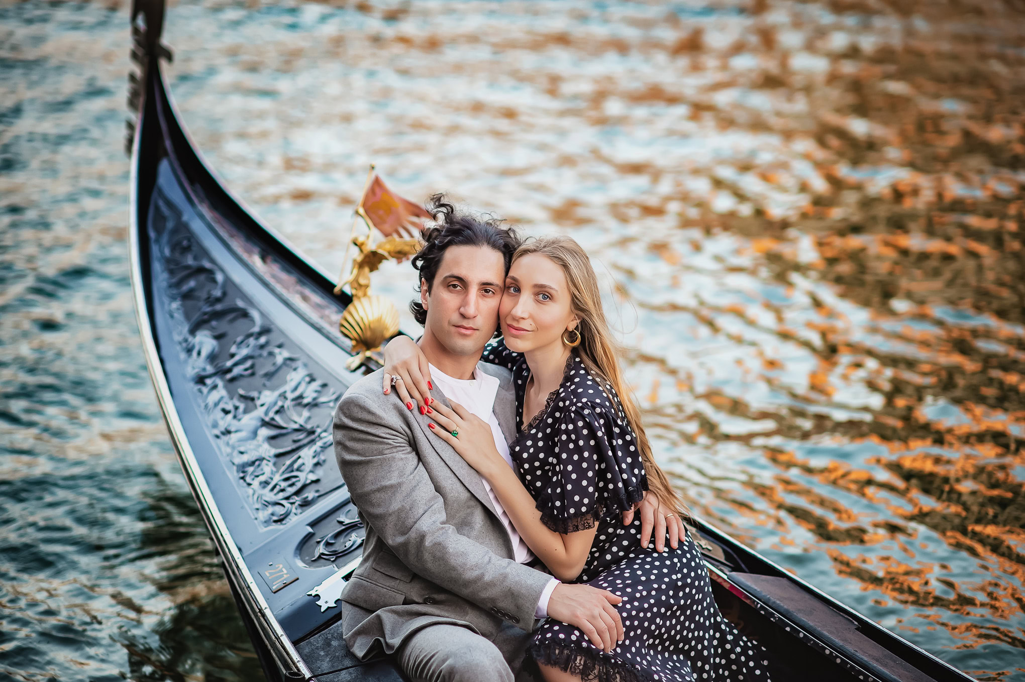 Two lovers sit closely in a gondola on a shimmering river at sunset, evoking intimacy and serenity i.